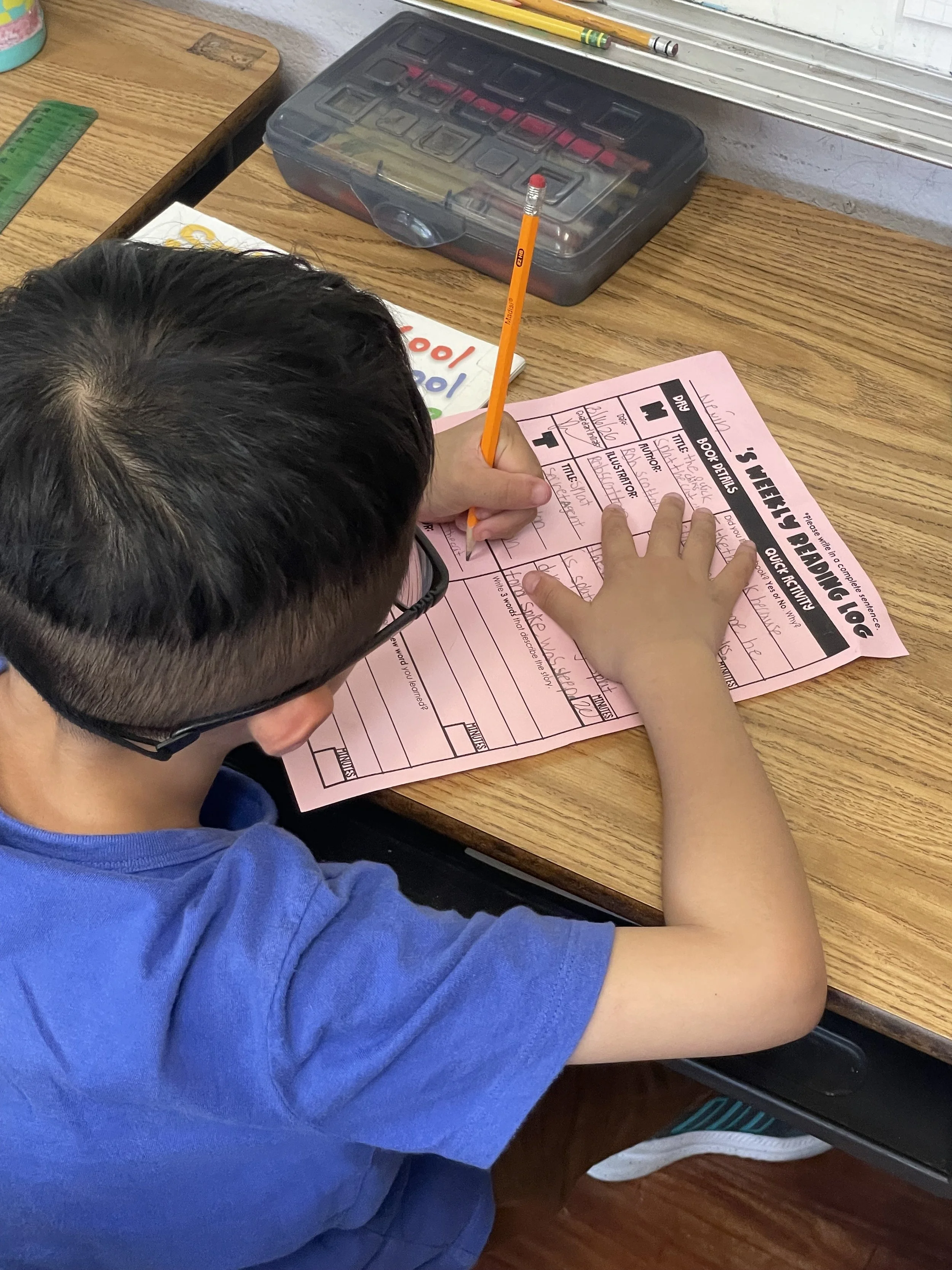 PT boy with glasses working on english.jpeg