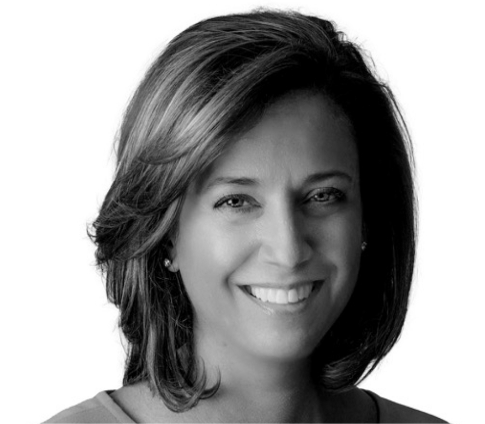 Black and white portrait of a woman with shoulder-length hair, smiling at the camera.
