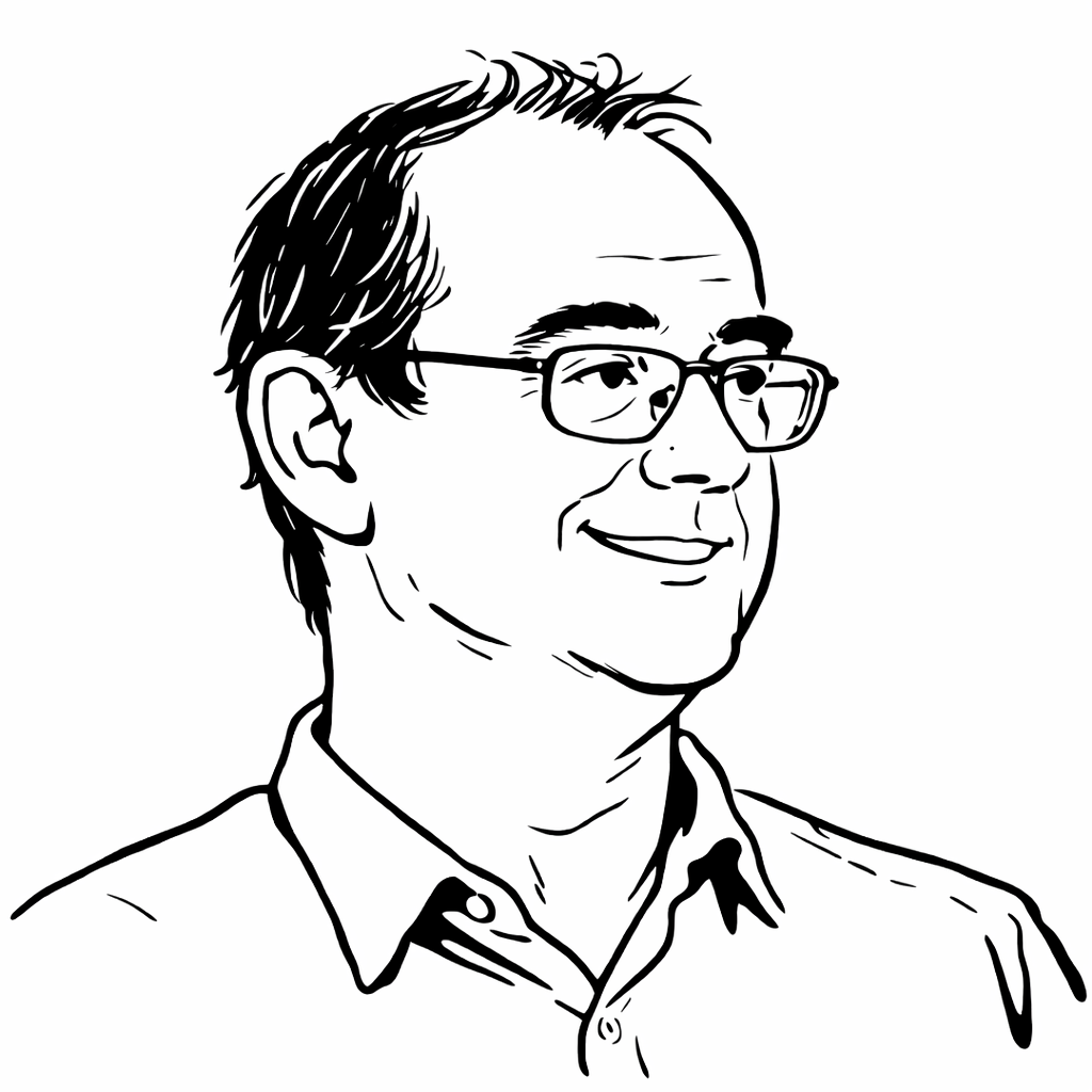 portrait d'un homme portant des lunettes, souriant, avec des cheveux courts et une chemise.