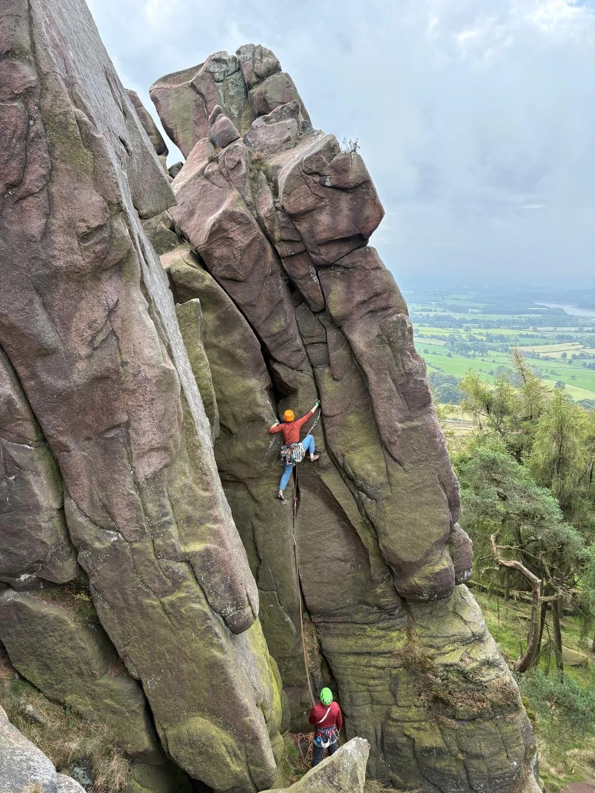 Climber leading a gritstone route