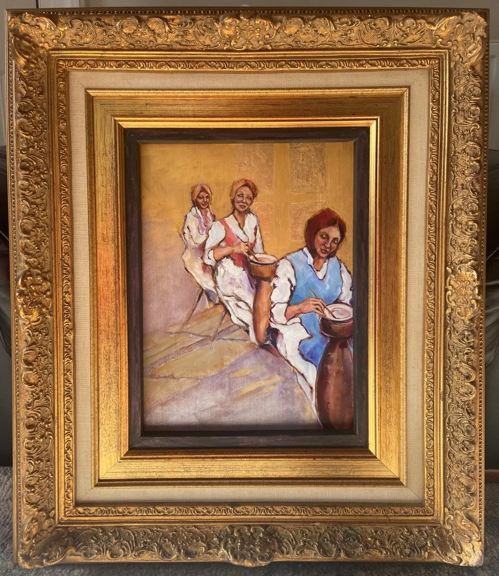 Painting of three people seated in a row working on pottery, framed by an ornate gold decorative frame.