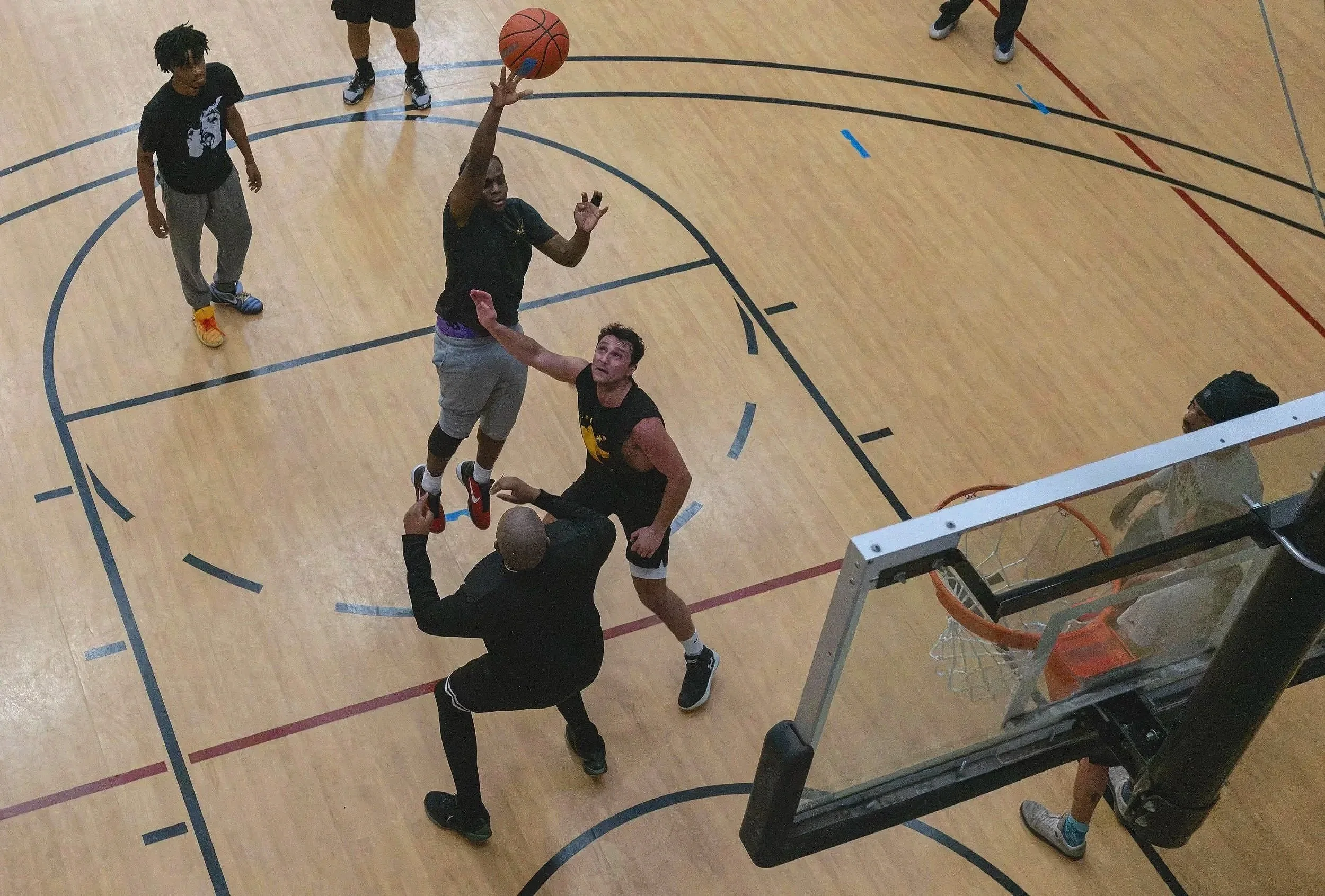 Students try to score a point against staff during a scrimmage basketball game in the East-West University gym on Wednesday, April 29, 2026.