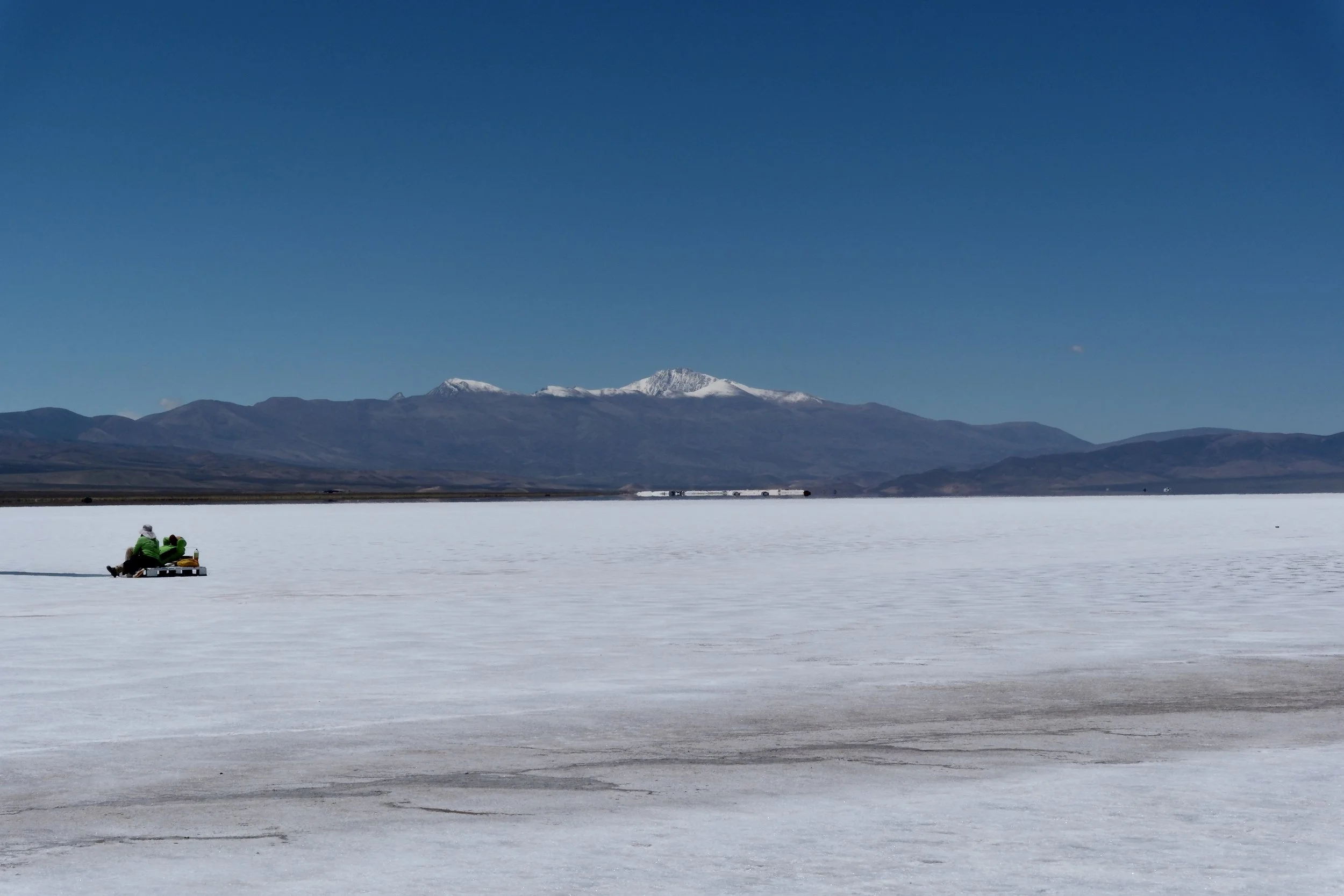 Two tour guides take a quick break at the Salinas Grandes in Jujuy, Argentina, on Jan. 9, 2026.