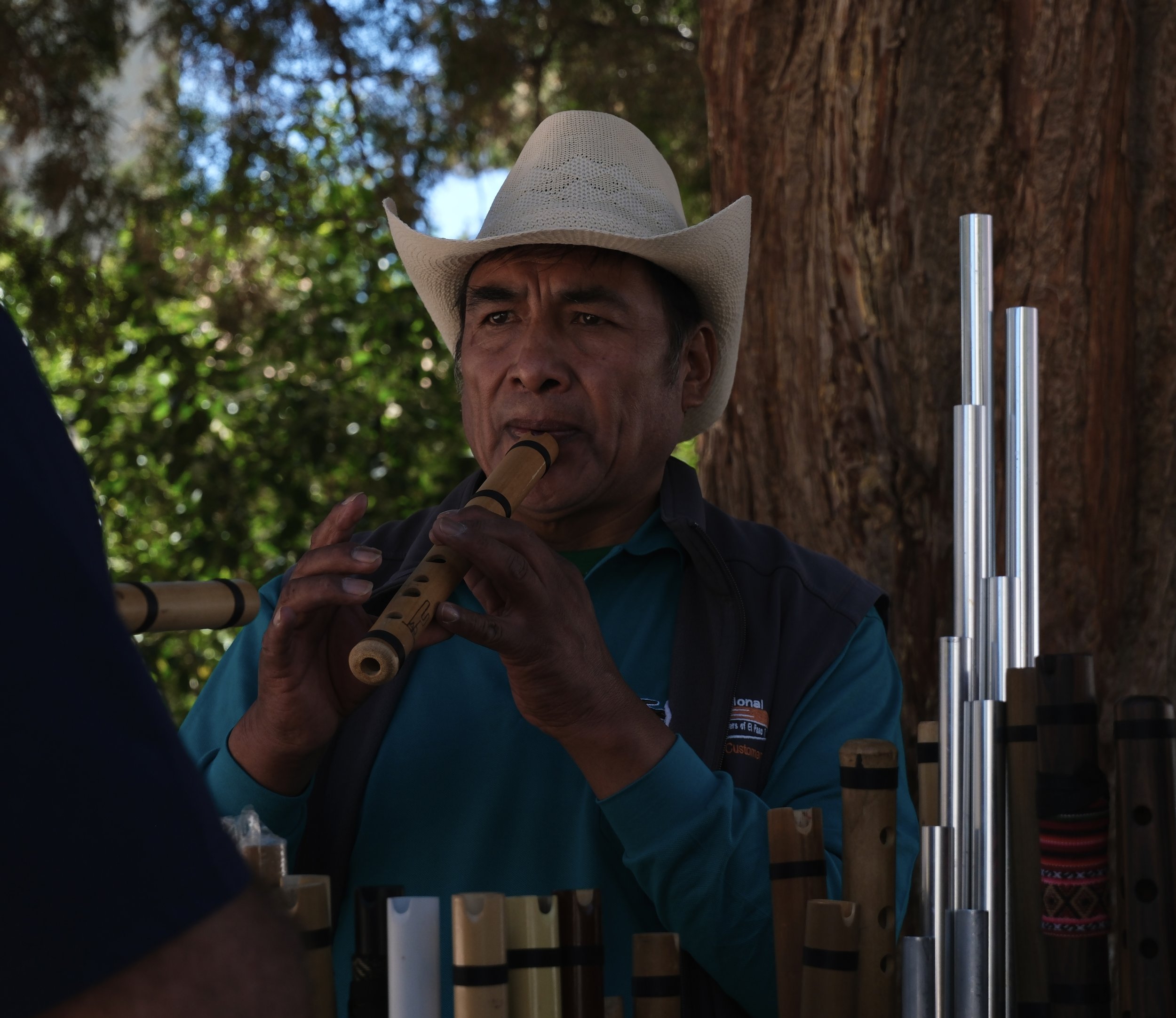 A salesperson demonstrates how to use one of the handcrafted flutes at an outdoor market in Humahuaca, Argentina, on Jan. 12, 2025.