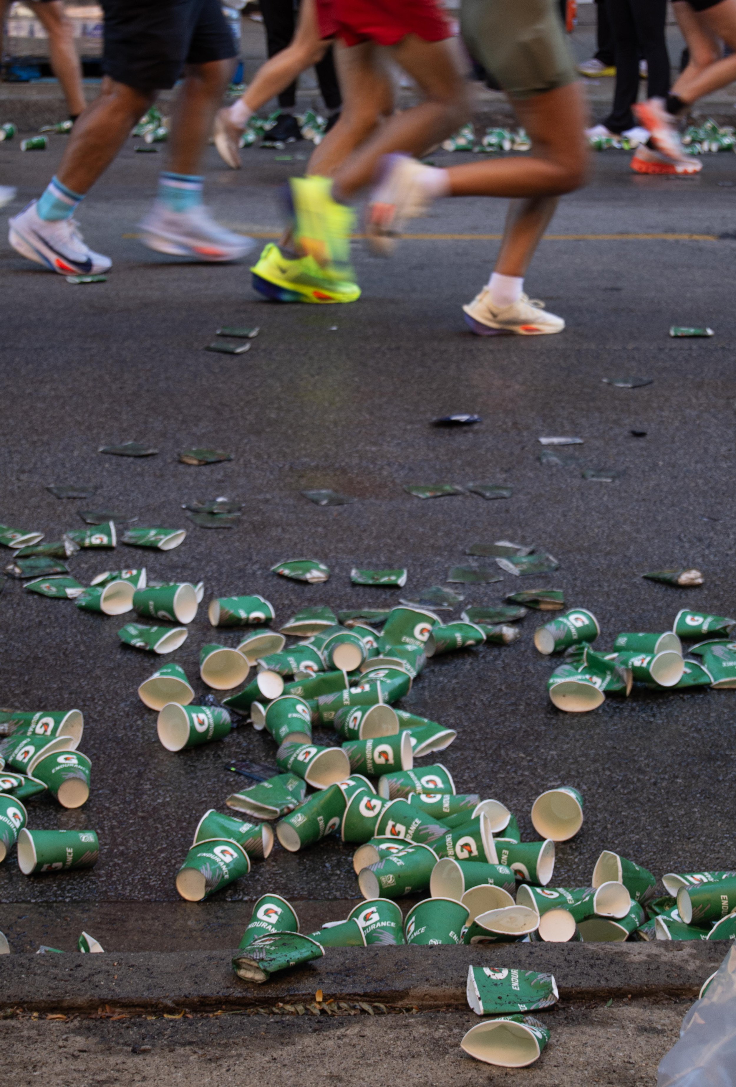 Discarded cups from one of the designated "cheer zones" build up in the street as runners continue along the route of the Bank of America Chicago Marathon on Sunday, Oct. 12, 2025.