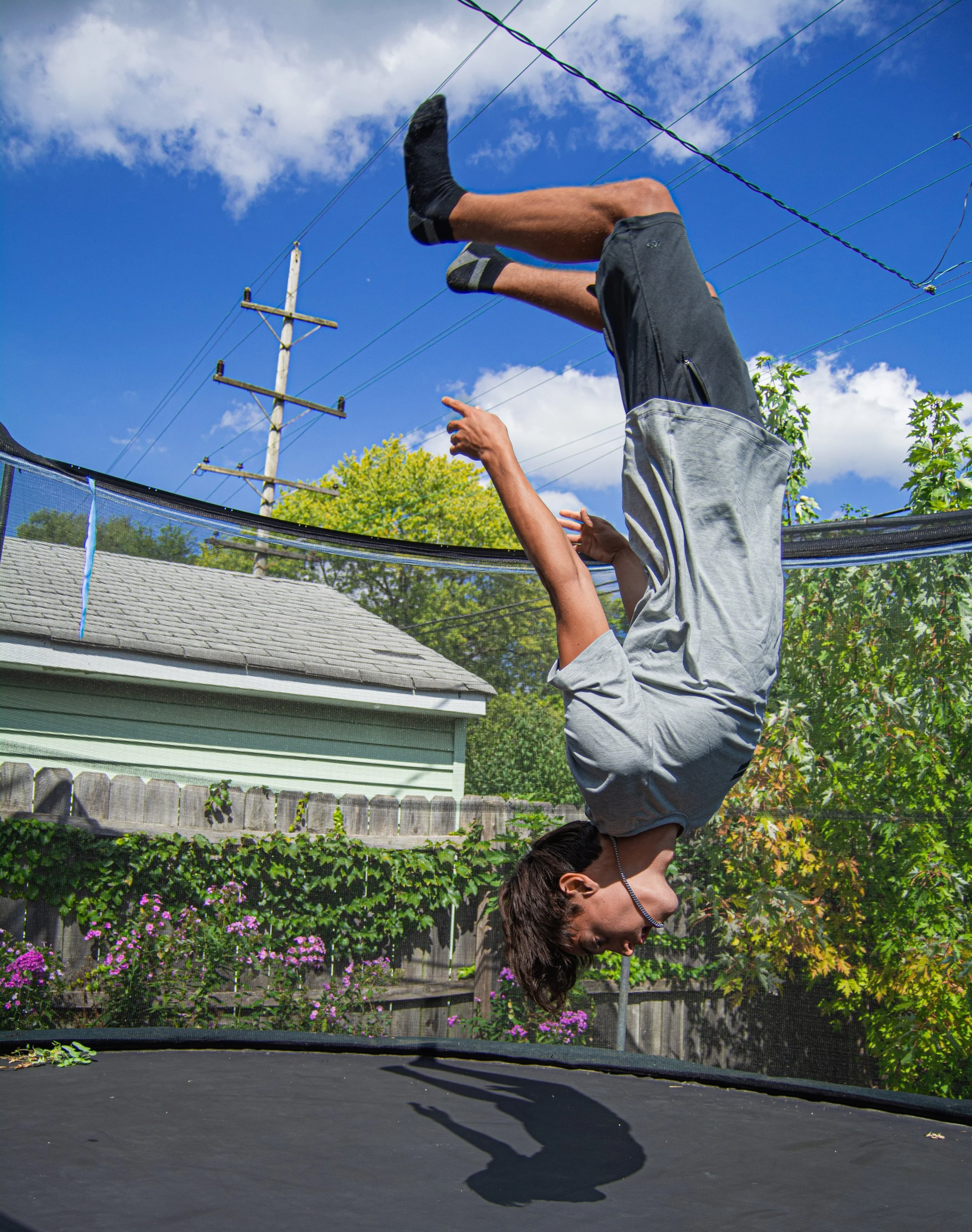 Tyler Jolly suspends mid-air as he practices backflips on a trampoline on Sept. 21, 2023.