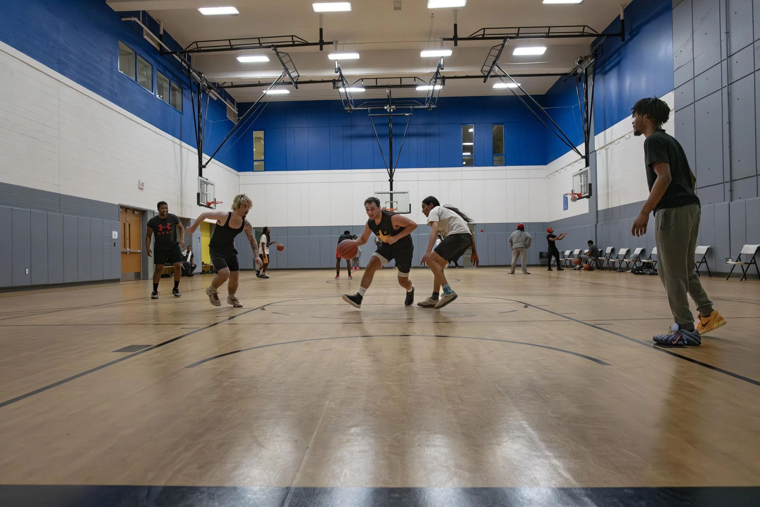 The Black Wolves basketball team warms up for their scrimmage basketball game in the East-West University gym on Wednesday, April 29, 2026.