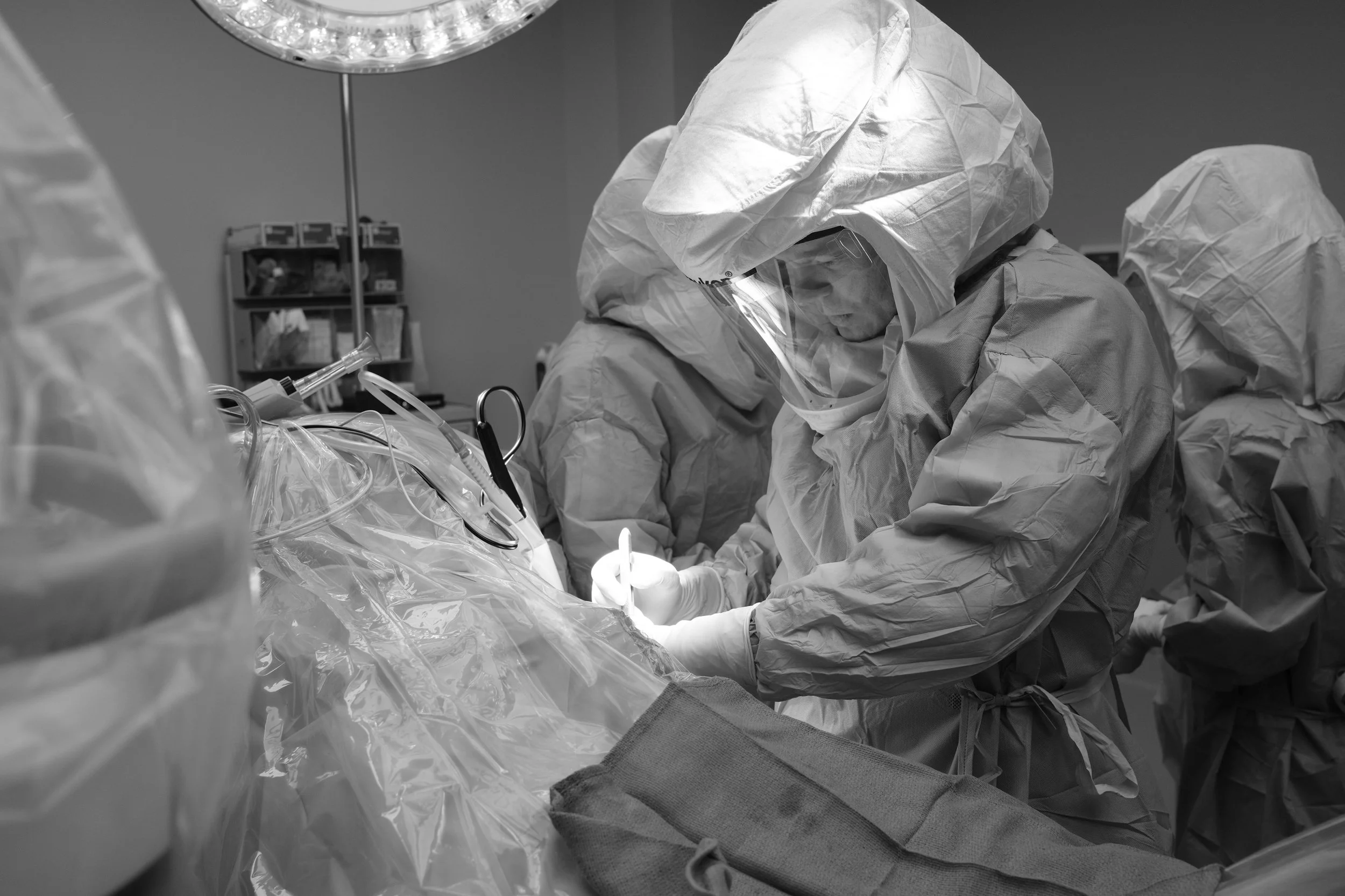 Orthopedic surgeon performing anterior hip replacement surgery in an operating room using advanced techniques.
