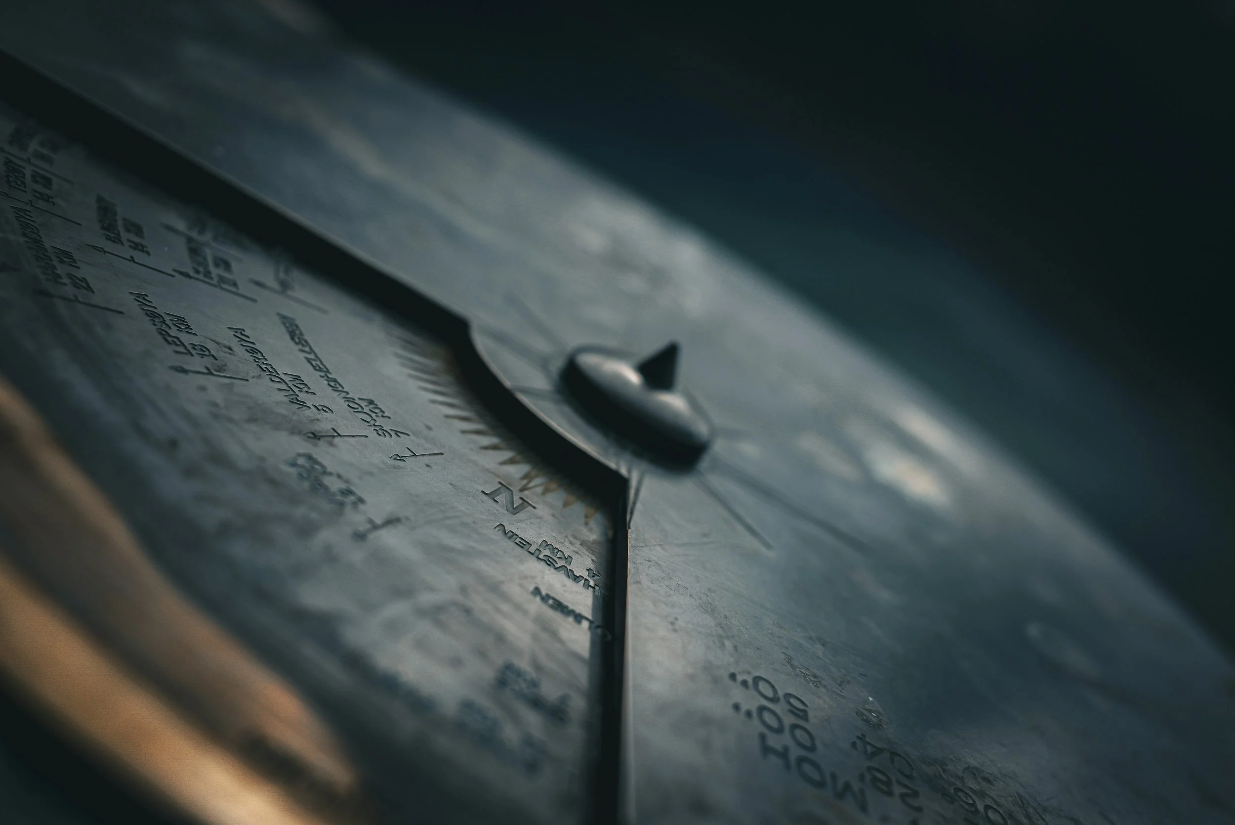 A close-up shot of the hour hand on a weathered analog clock, showing the time as approximately 4:35.