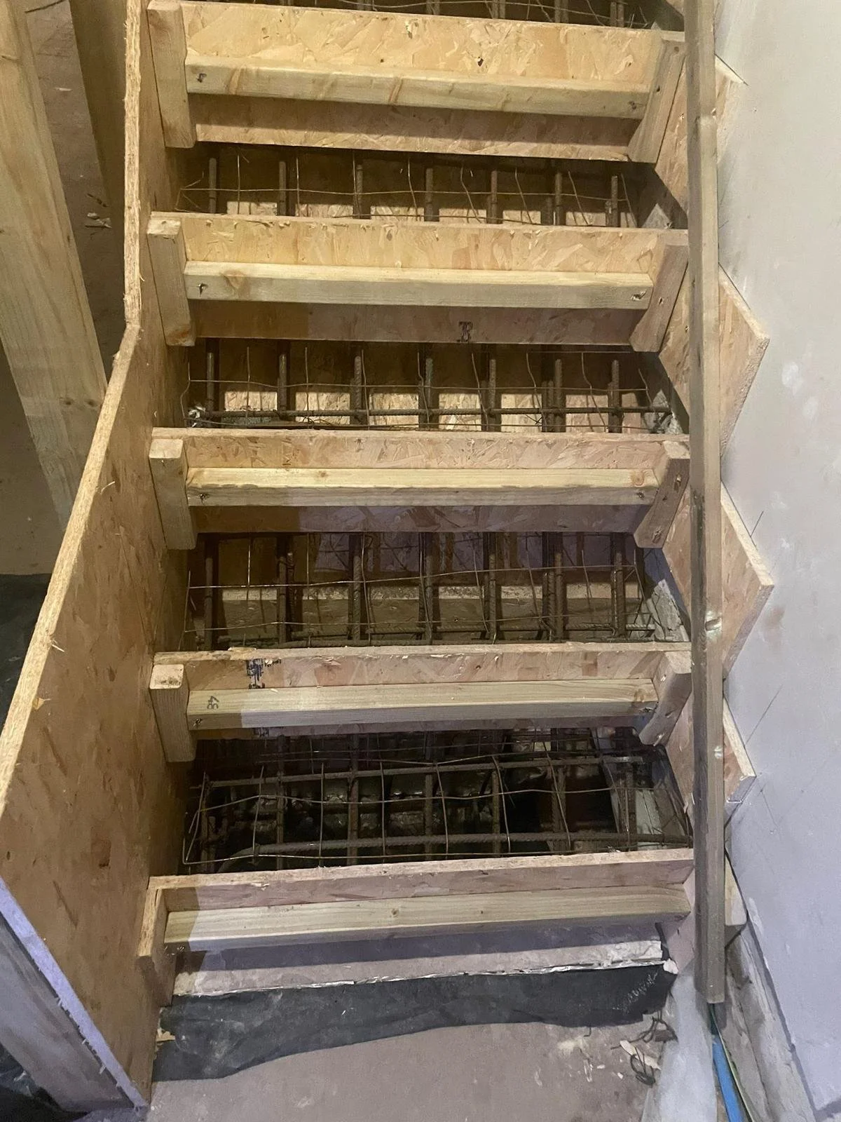 Construction site showing shuttering ready for the installation of new concrete stairs 