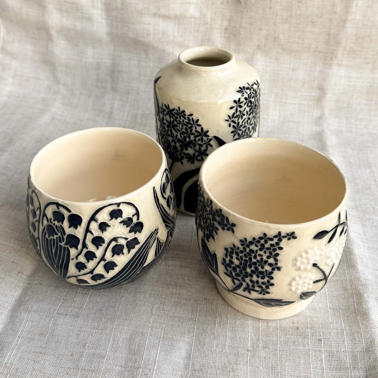 More hopeful spring designs #allium #lilyofthevalley #lilacs #sgraffito #mainepottery