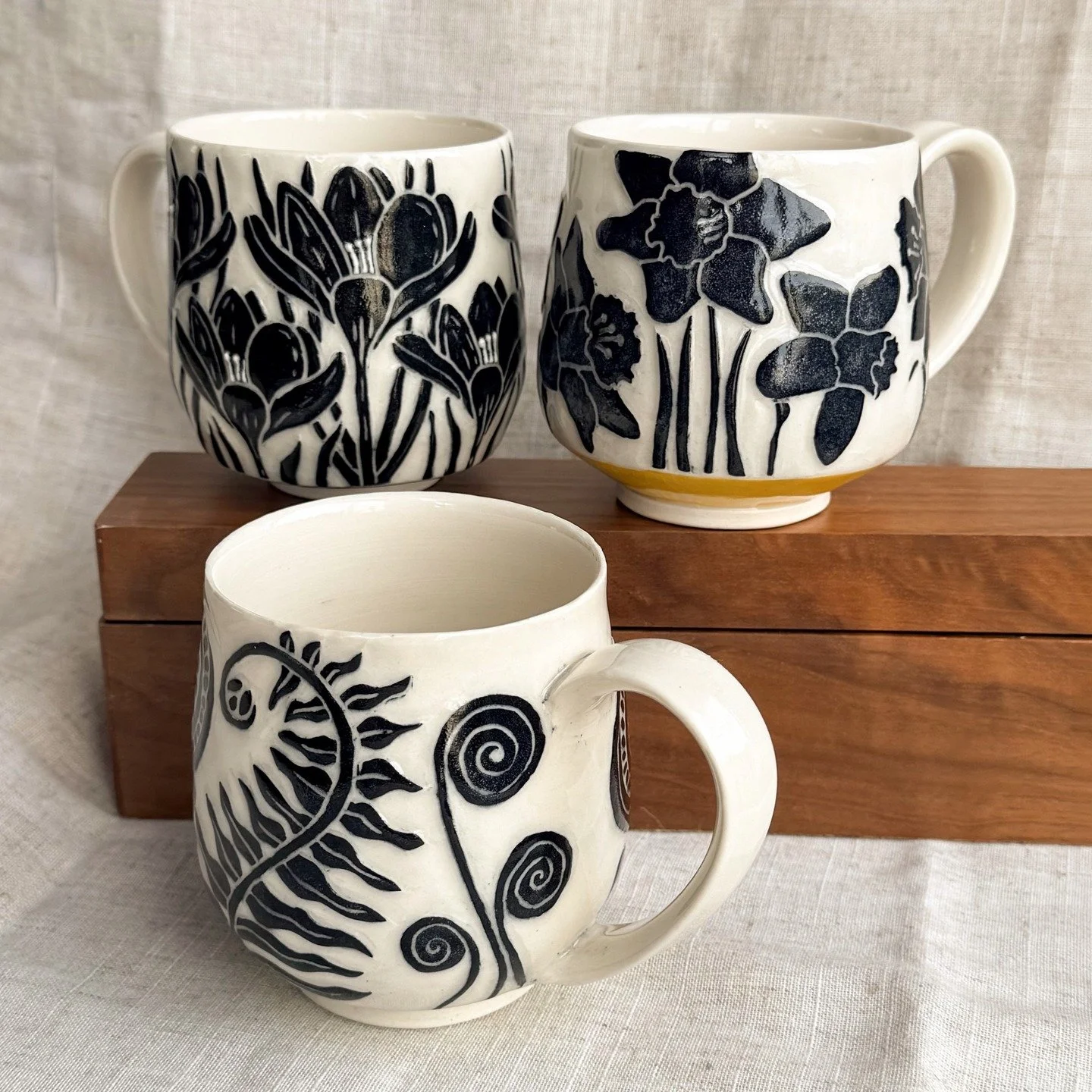We've had some great snow melt over the past few days, so there's hope we'll see some spring flowers soon. It's inspiring me to carve some spring-themed mugs. #crocus #daffodils #fiddleheads #sgraffito #mainepottery