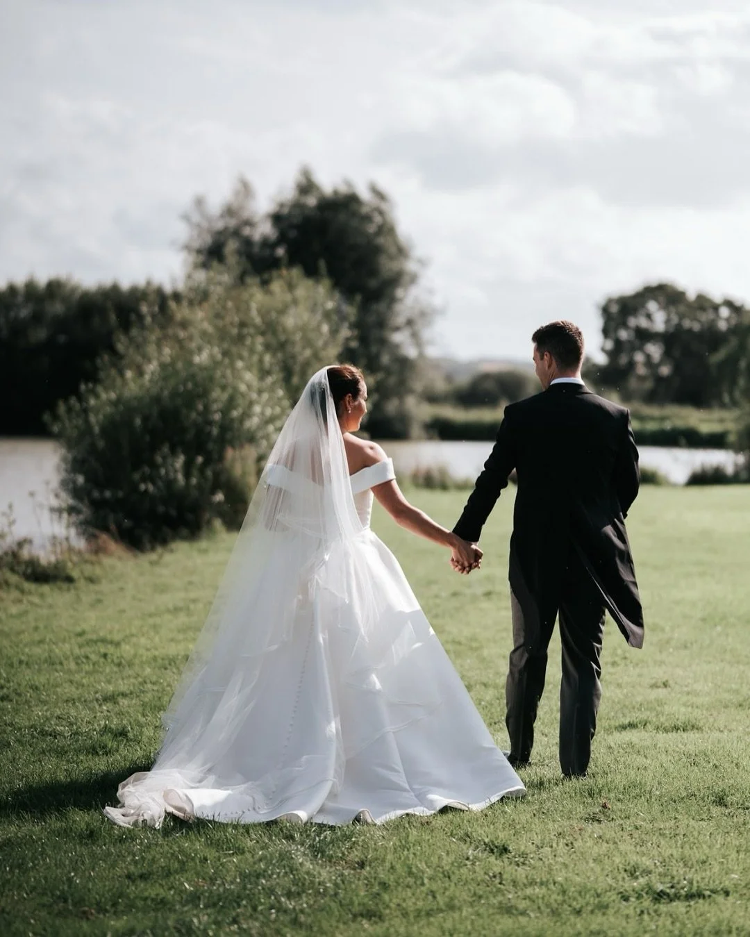 bridal wedding couple walking through fields