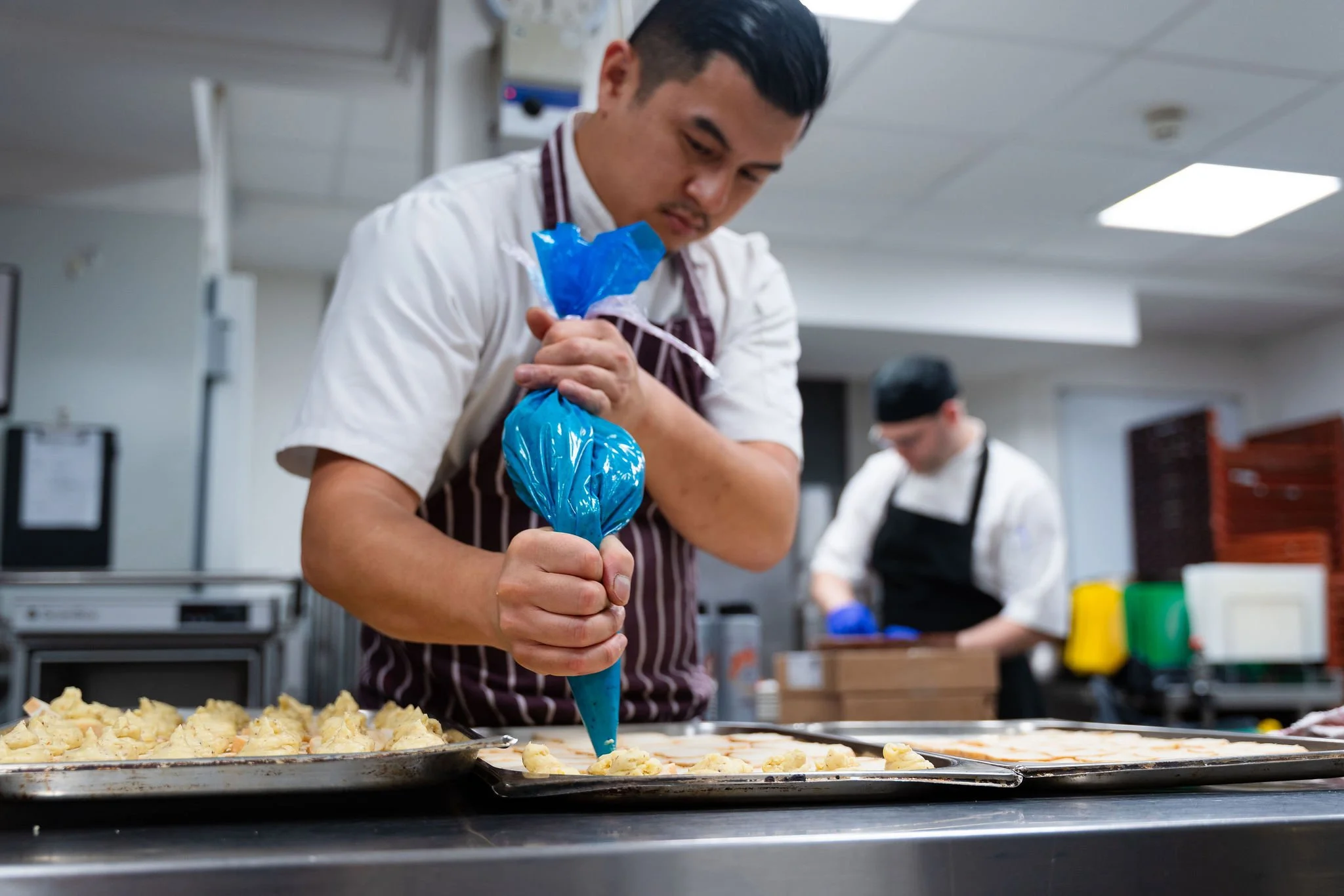head chef jon piping potato on to baking tray