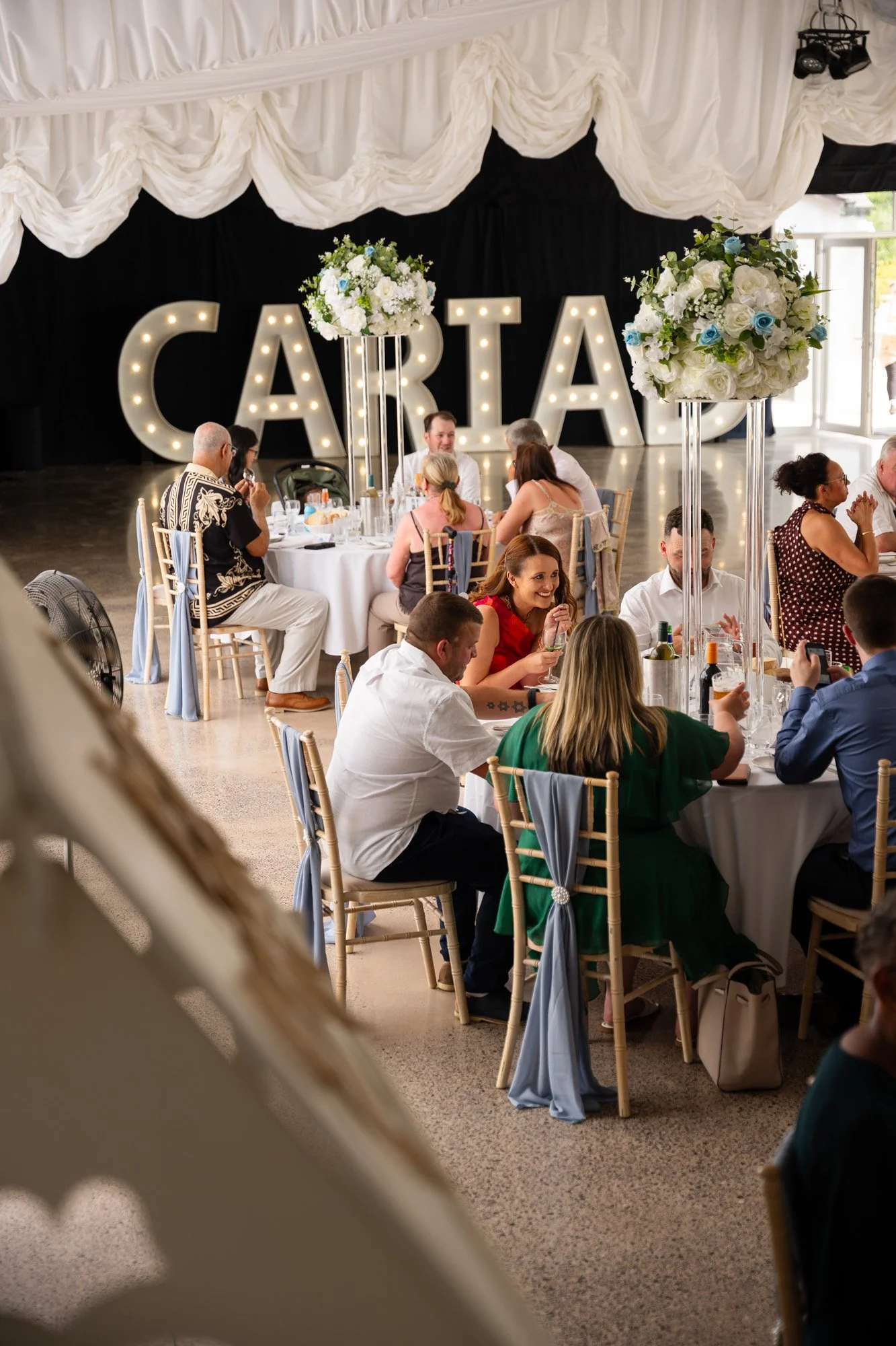 dyffryn springs inside marquee during wedding with happy guests