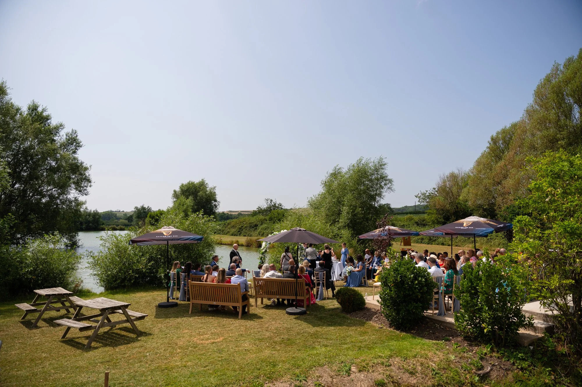 guests milling on lawn at dyffryn springs after wedding ceremony