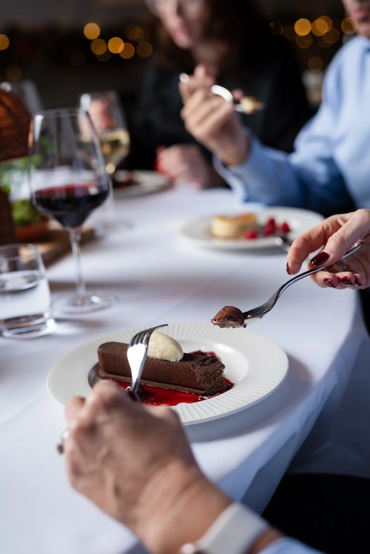 Eating chocolate dessert at a well dressed table