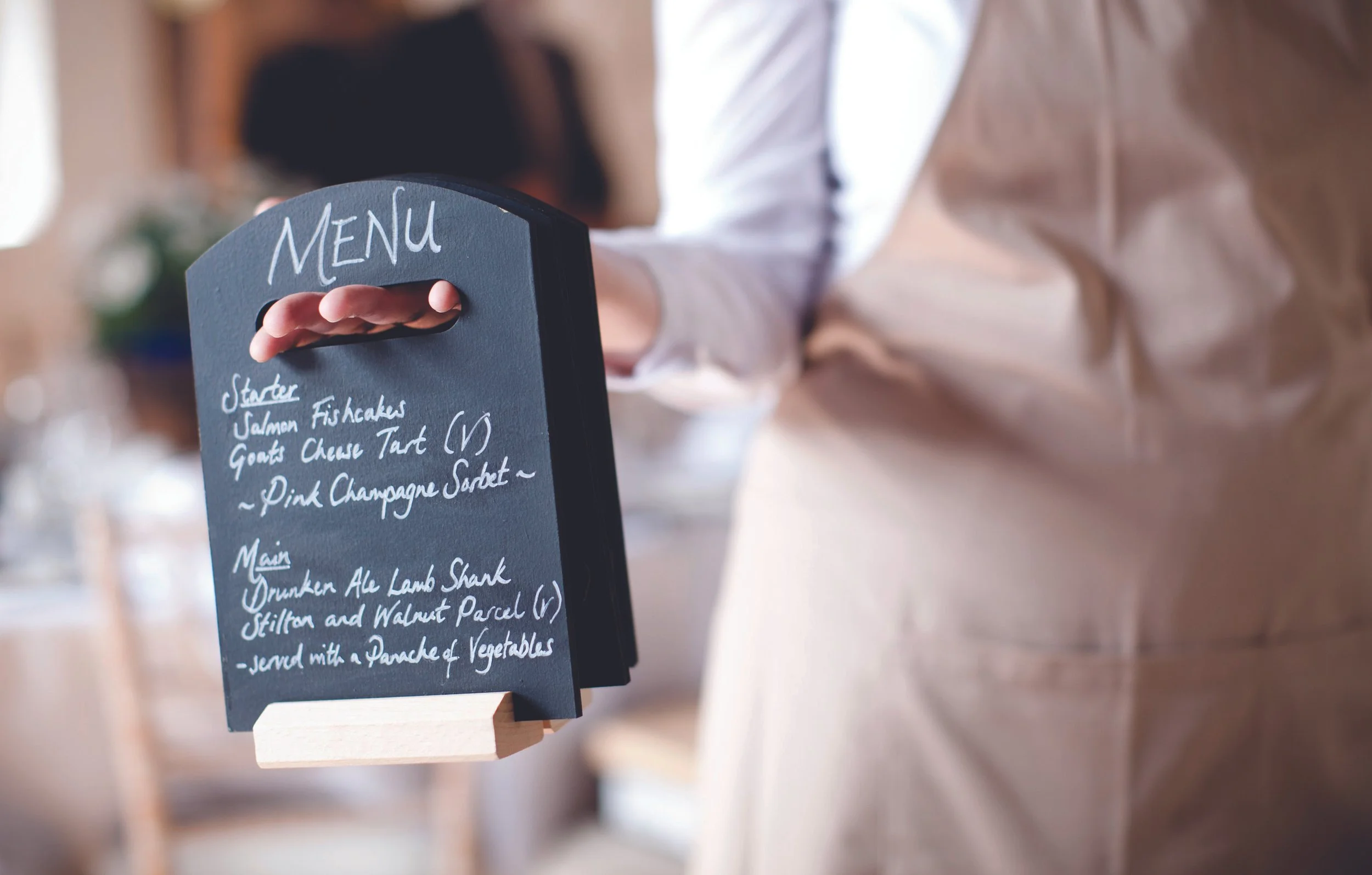 wedding menu held by catering team