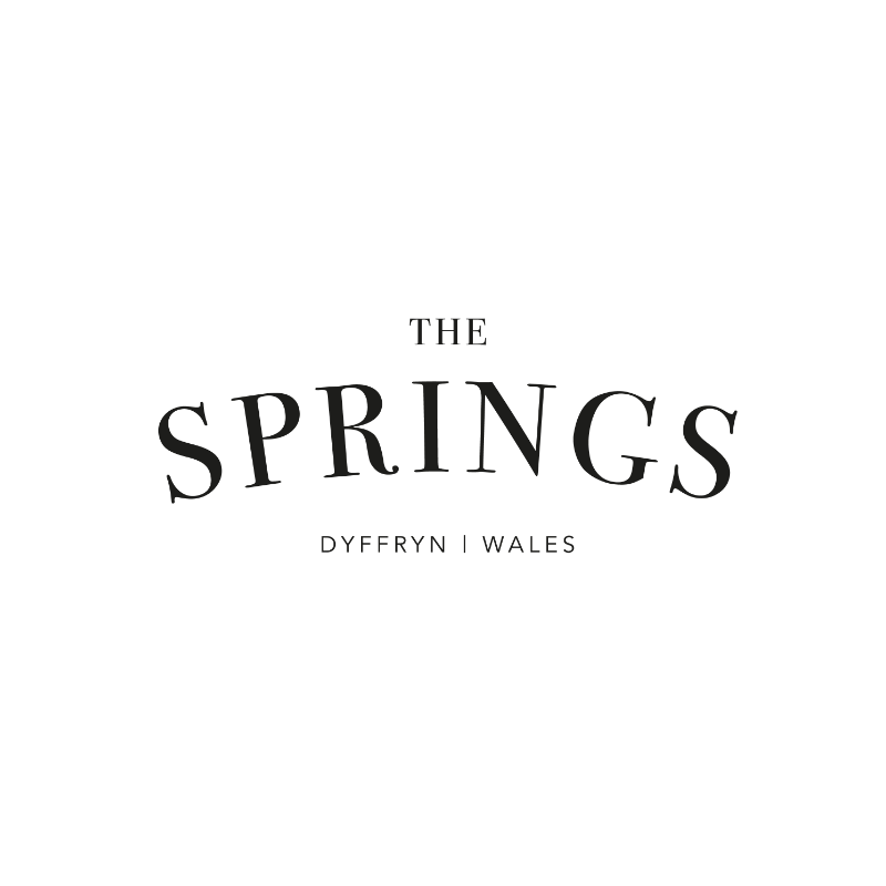 Text stating "The Springs Dyffryn Wales" with a scenic background of spring flowers and trees.