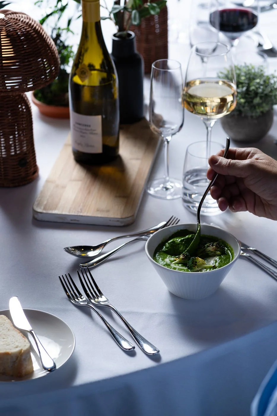 guest eating green soup in bowl