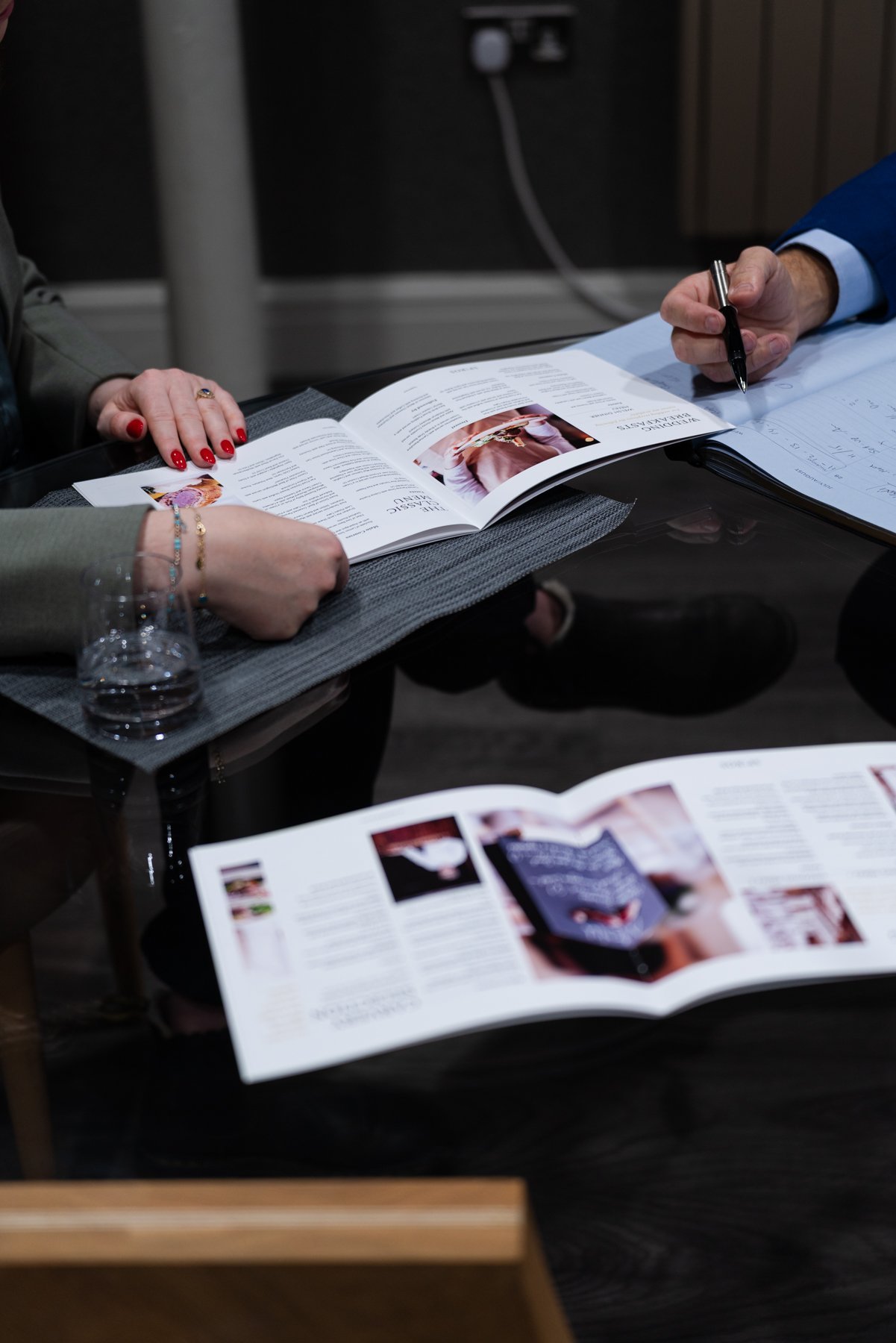 spiro and guest looking through brochures at menu ideas