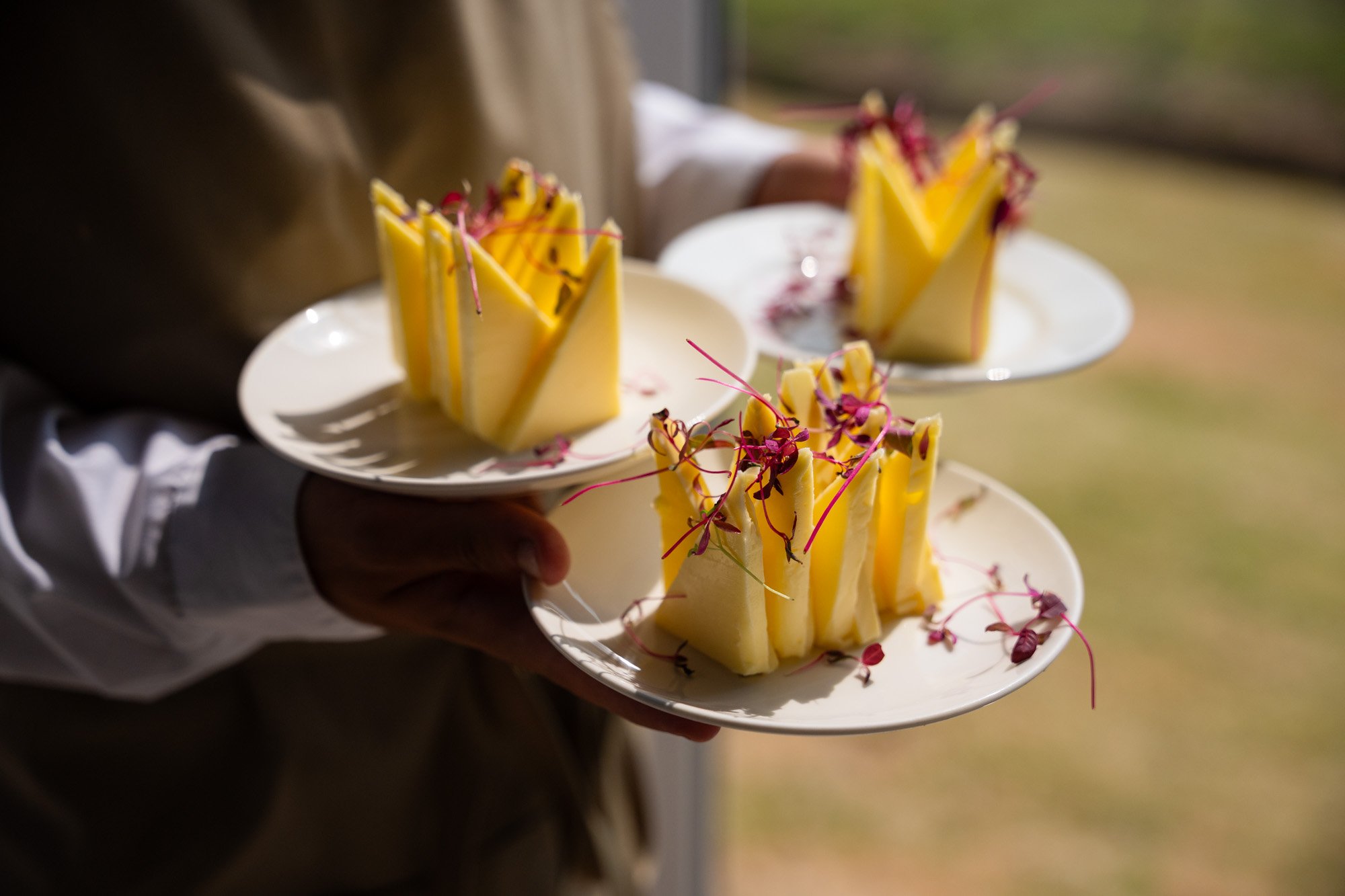 butter triangles held by catering team member, spiros