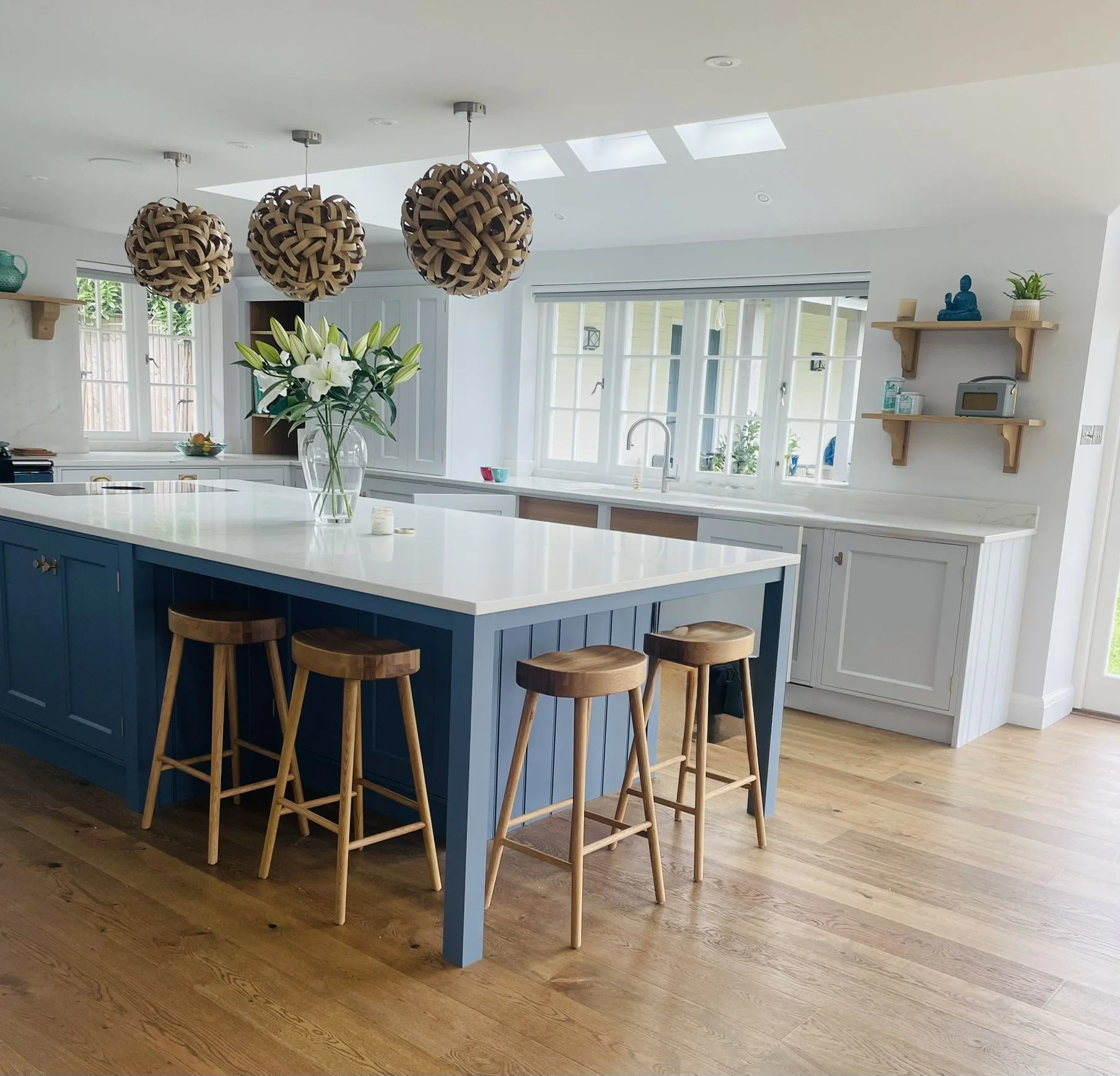 Painted kitchen with large central island, bar stools and rooflights