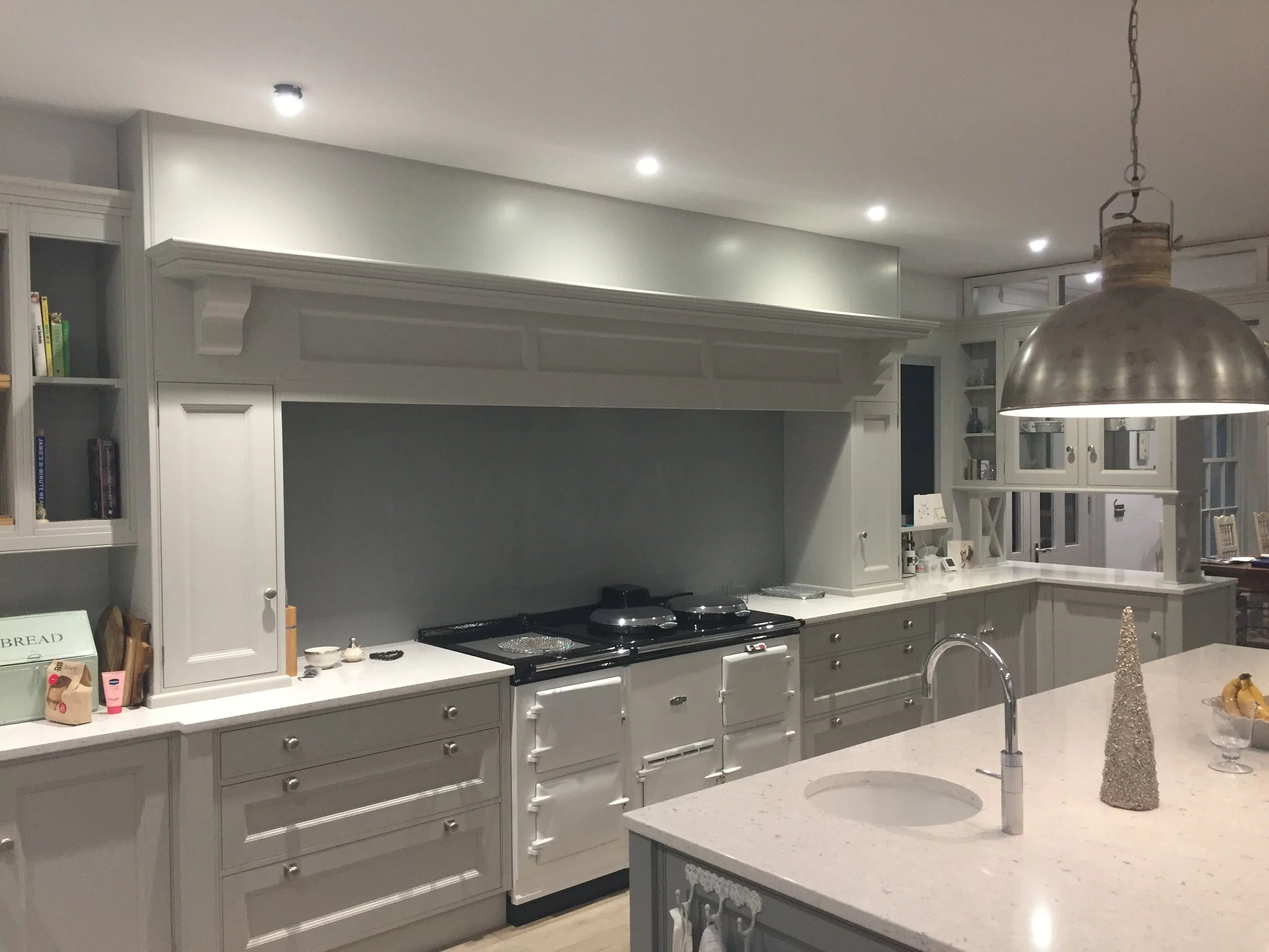 Bespoke painted kitchen with traditional overmantle, range cooker and detailed cabinetry