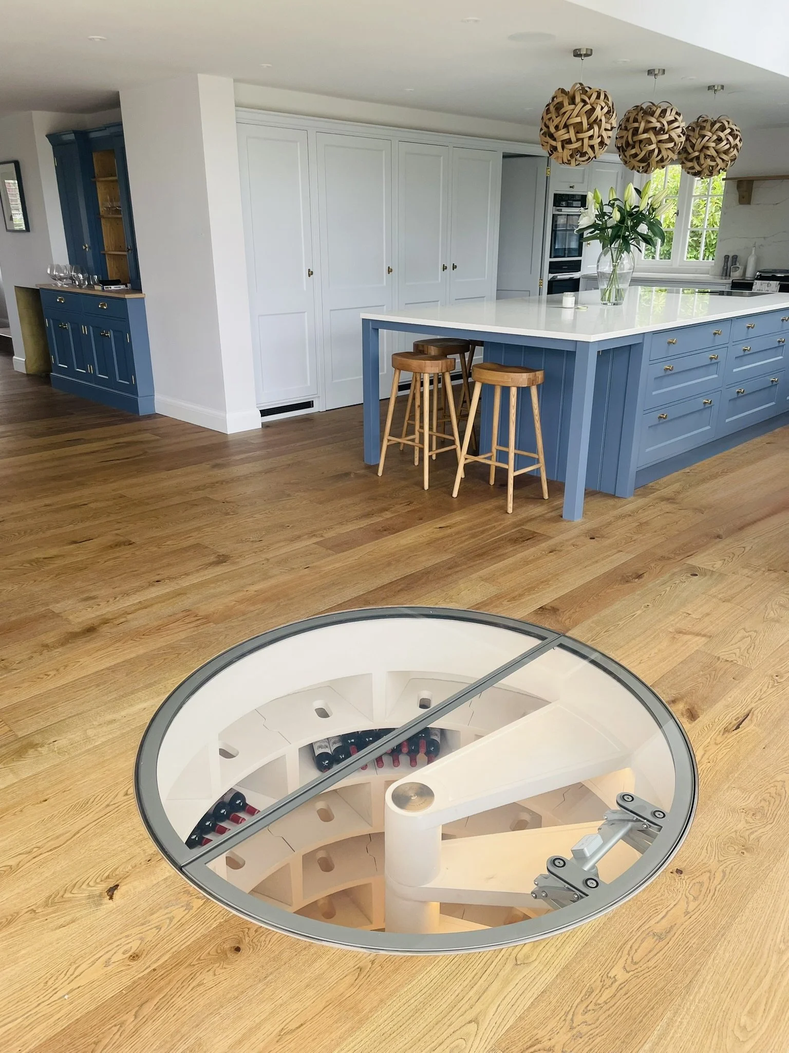 Open-plan kitchen with central island and spiral staircase