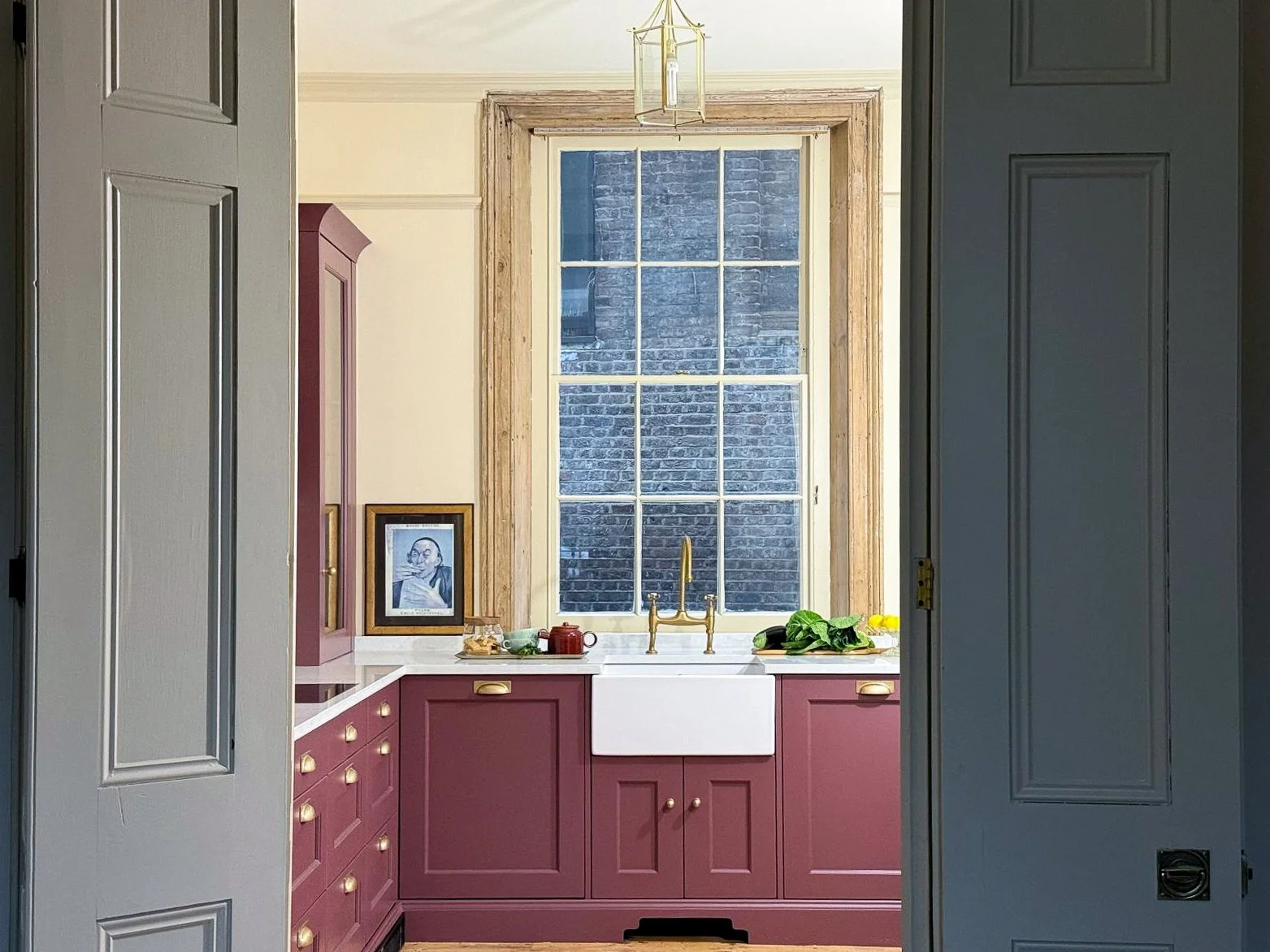 Bespoke painted kitchen framed by original double doors