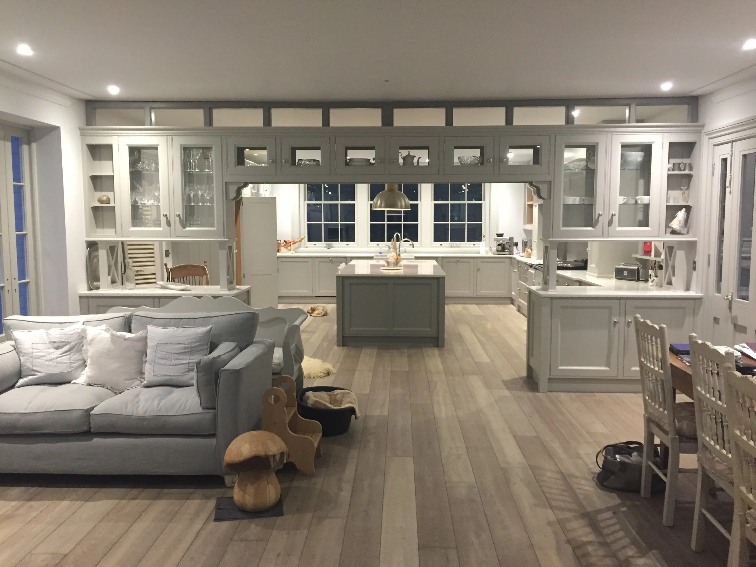 Bespoke painted kitchen opening into an open-plan living and dining space