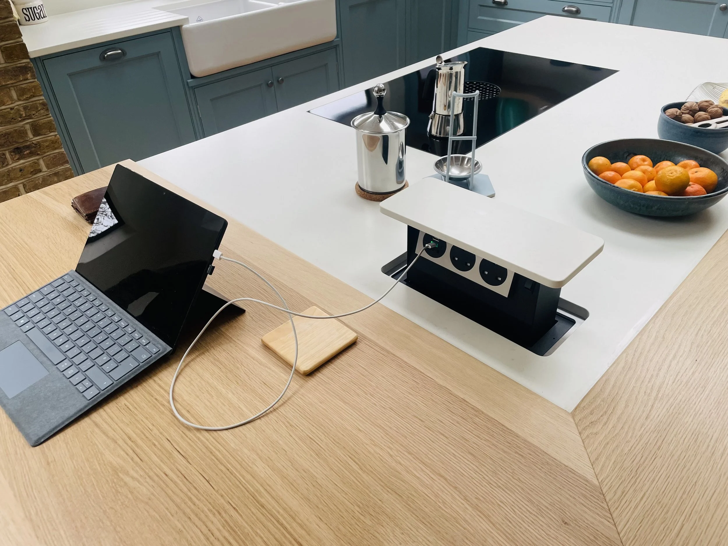 Pop-up power socket integrated into a bespoke kitchen island in Beckenham