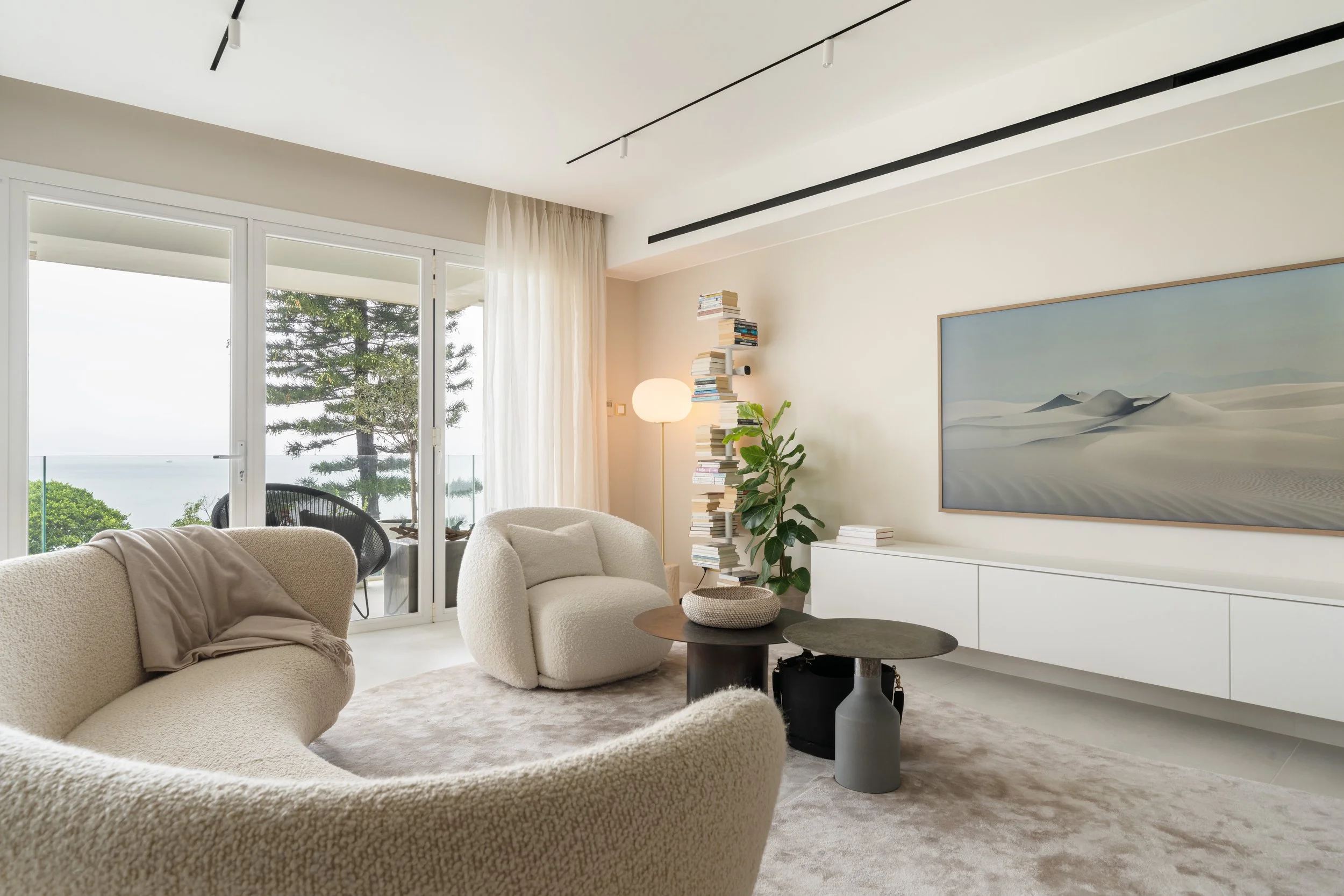 Hong Kong beachfront apartment adds second floor for a duplex that’s all about the sea view, with minimal decor and maximum storage