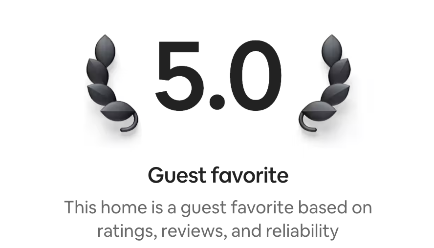 A digital review badge with a black laurel wreath on each side, a score of 5.0 in the center, and the label 'Guest favorite' beneath it, indicating a highly recommended home based on reviews and ratings.