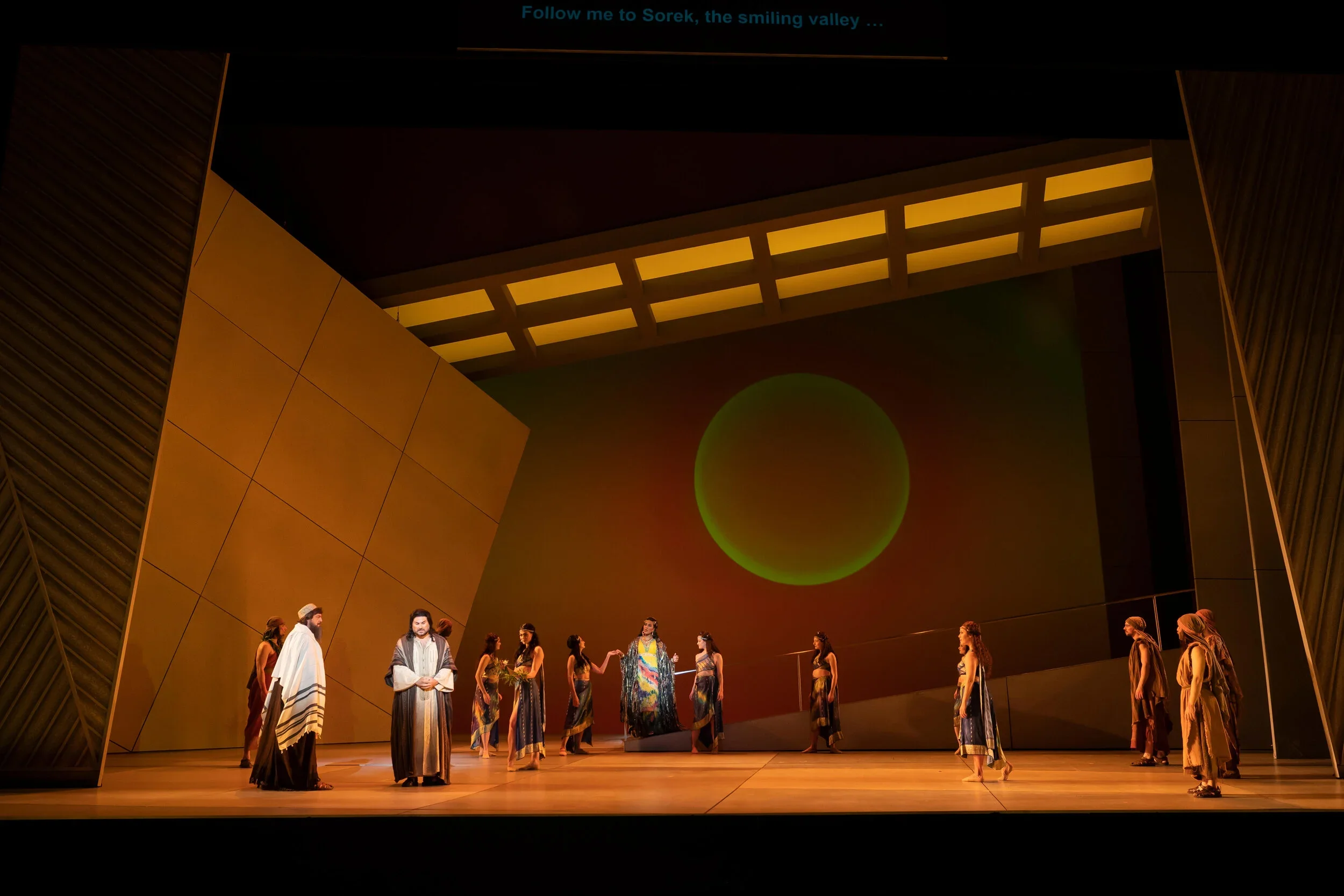 The Old Hebrew (Peter Volpe) warns Samson (Roberto Aronica) to avoid Delilah (J’Nai Bridges), who is listening in the background. Photo by Scott Suchman; courtesy of Washington National Opera.


