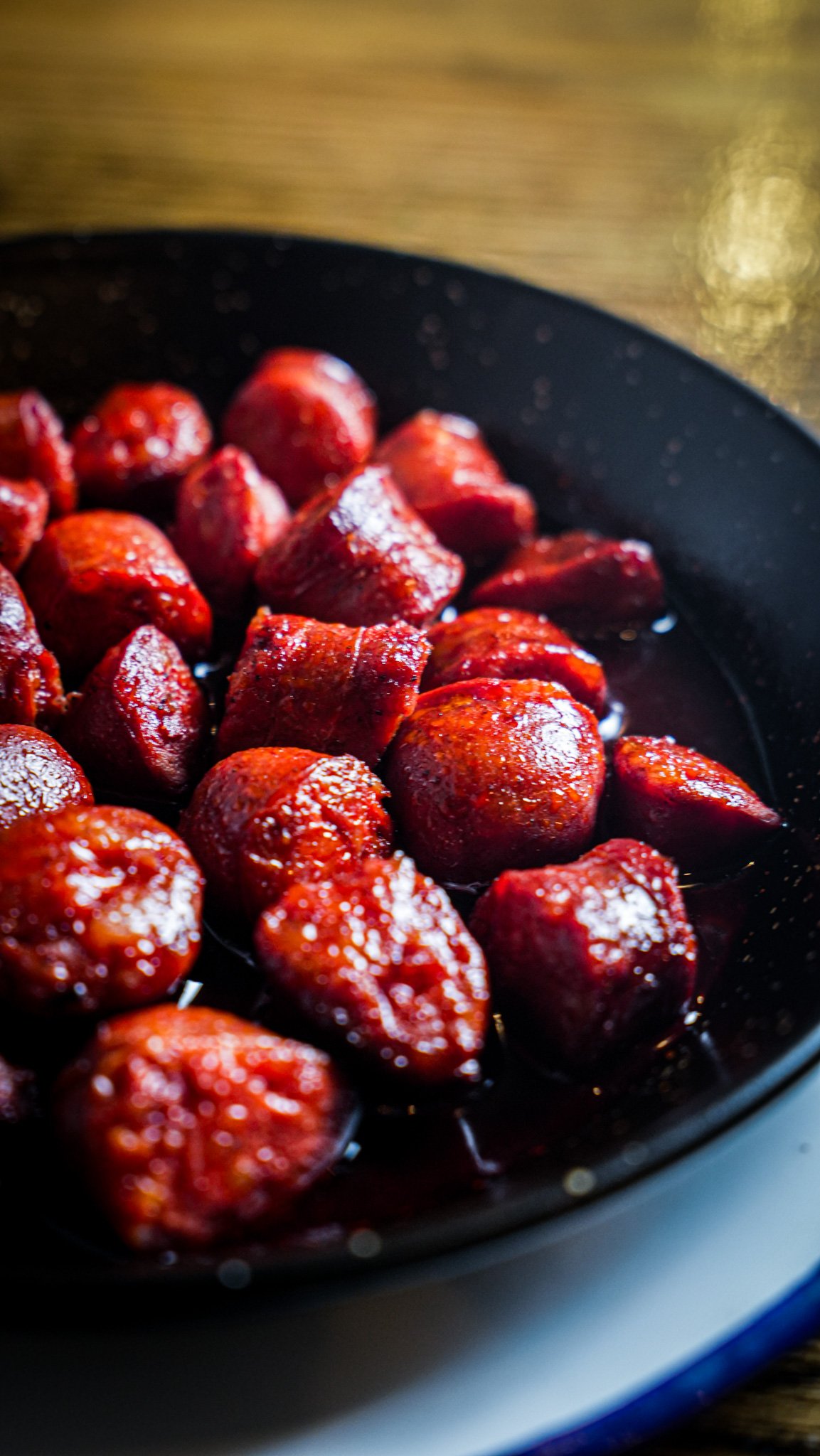 Close-up of cooked strawberries in a black pan
