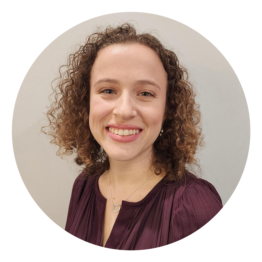 Photo of a woman with curly hair smiling at the camera - Program Manager for the Horn of Africa Think Peace Hannah Adamson