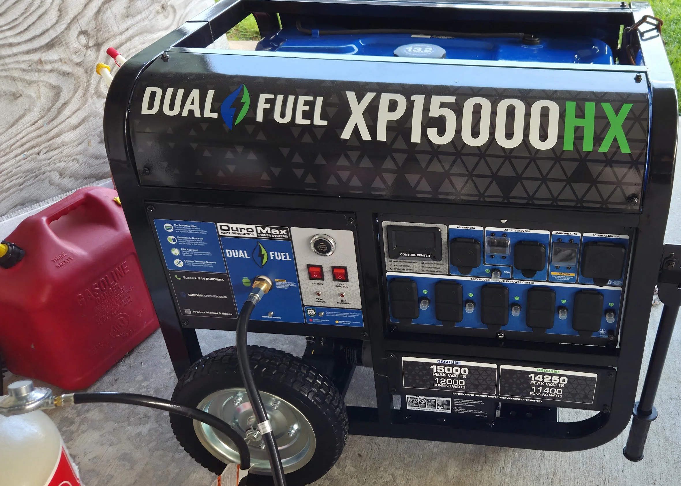 A portable dual fuel generator with a black frame, labeled Xp1500HX, featuring various switches and outlets, with a red gasoline container and a propane tank nearby.