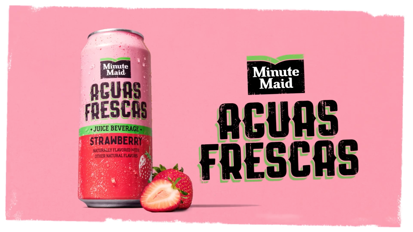 A pink can of Minute Maid Acuas Frescas strawberry juice beverage with fresh strawberries in front, set against a pink background with bold black and green text.