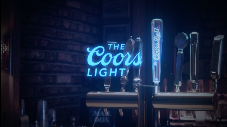 Beer tap handle with illuminated neon sign reading 'The Coors Light' behind a row of beer tap handles.