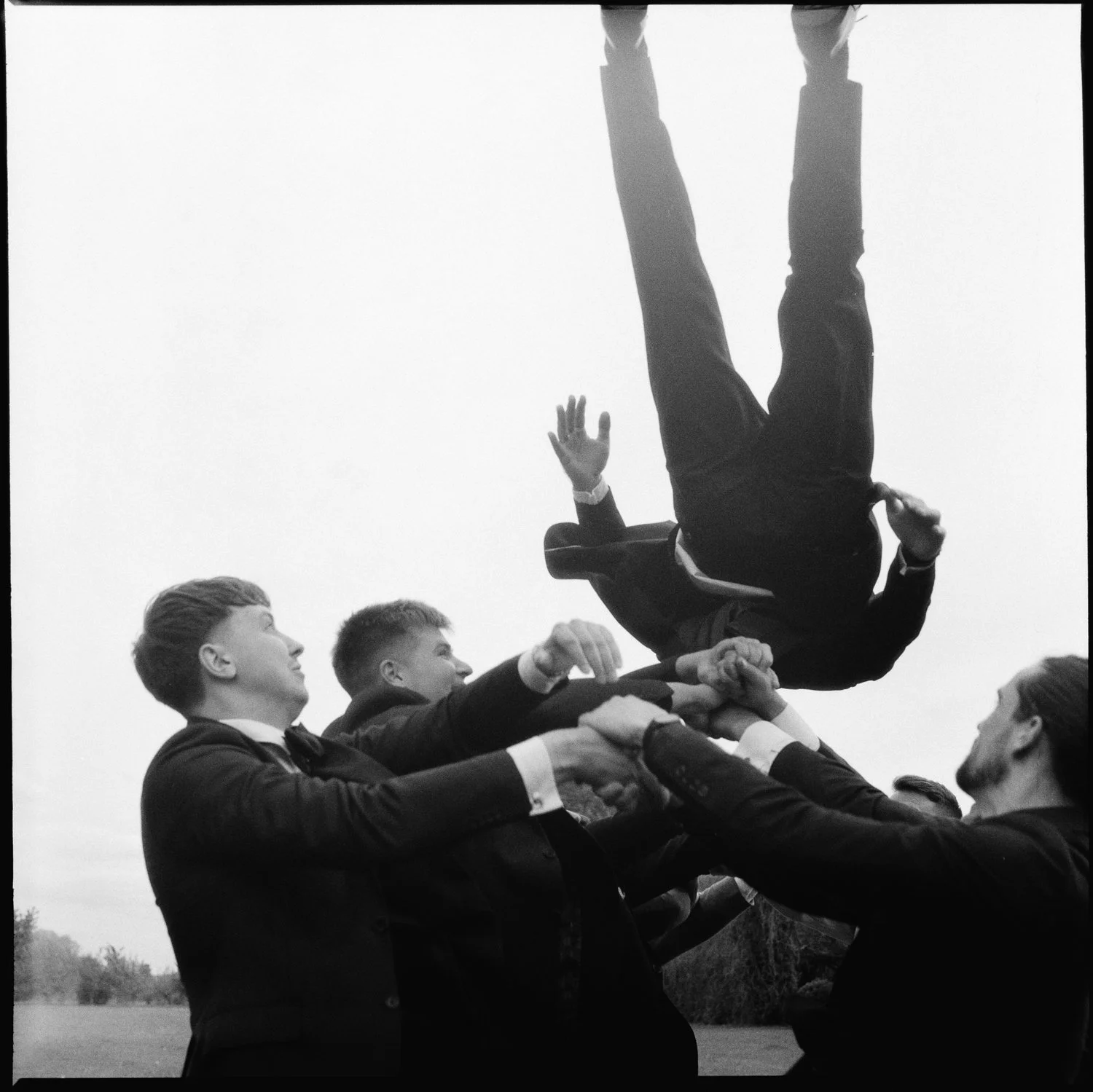 groom is being recognised by his mates and friends and peers while jumping in the air