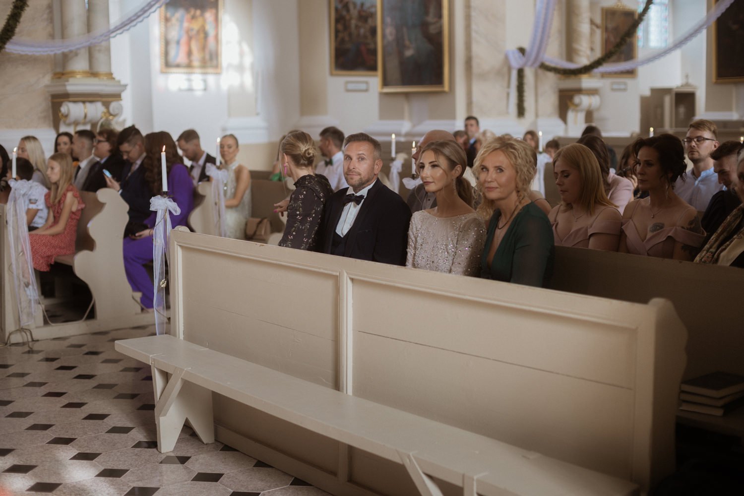 People seated in a church during a wedding ceremony