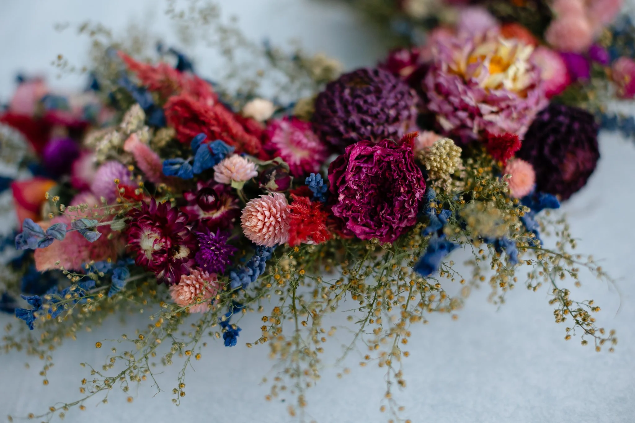 Close up view of dried florals on a wreath.