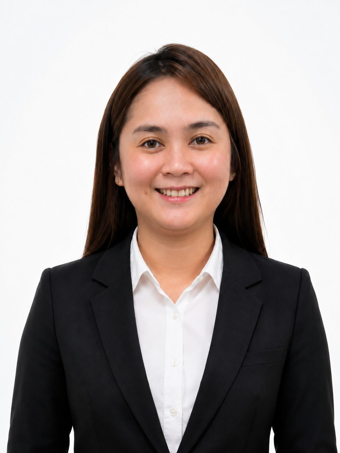 A young woman with long brown hair, wearing a black blazer and white shirt, smiling in front of a plain white background.