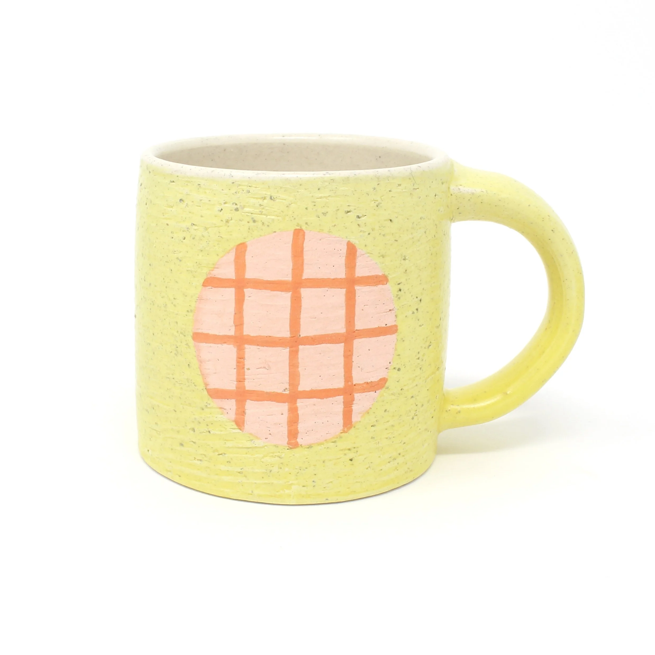 yellow mug with pink plaid design
