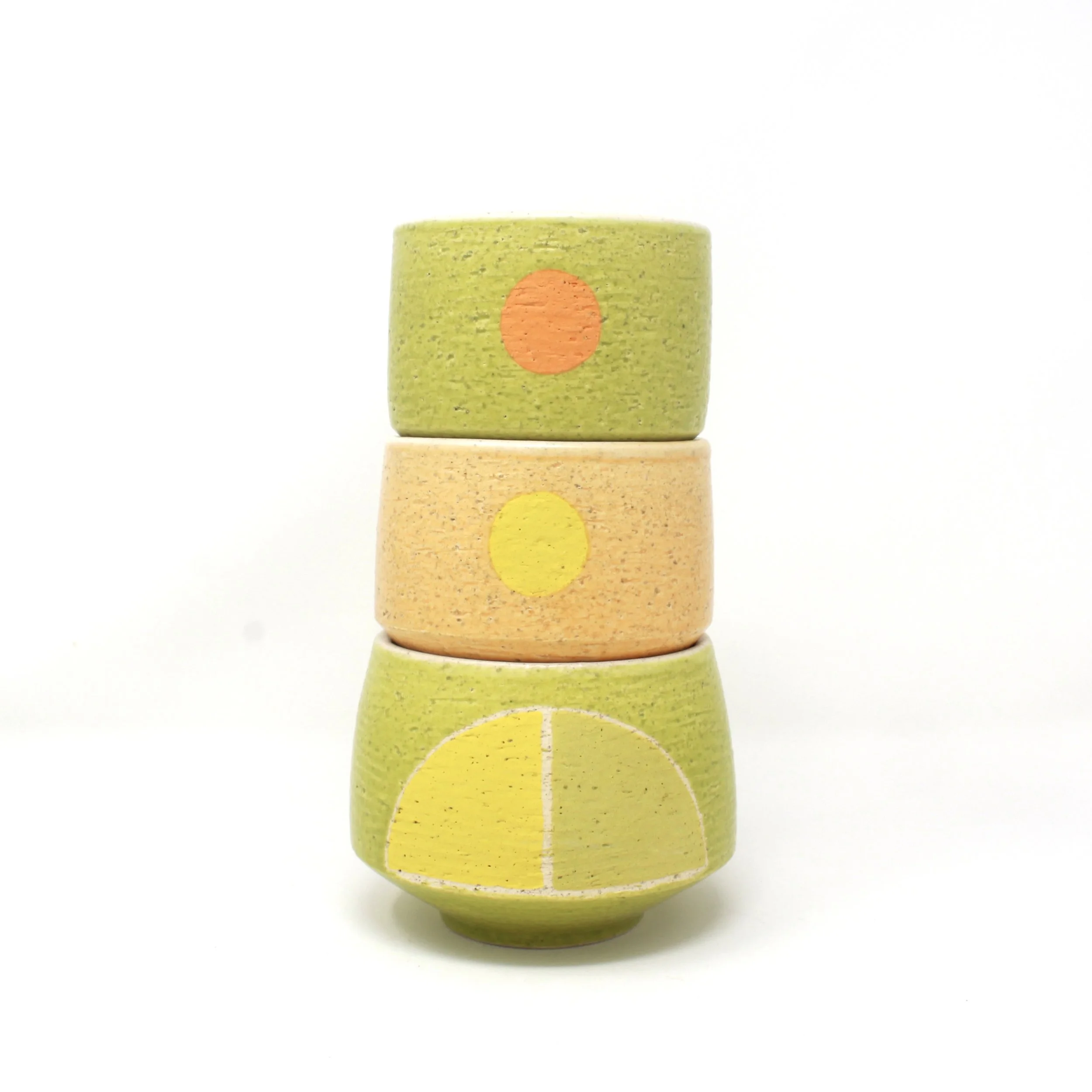 3 cups stacks in oranges and greens with circles and half circle designs
