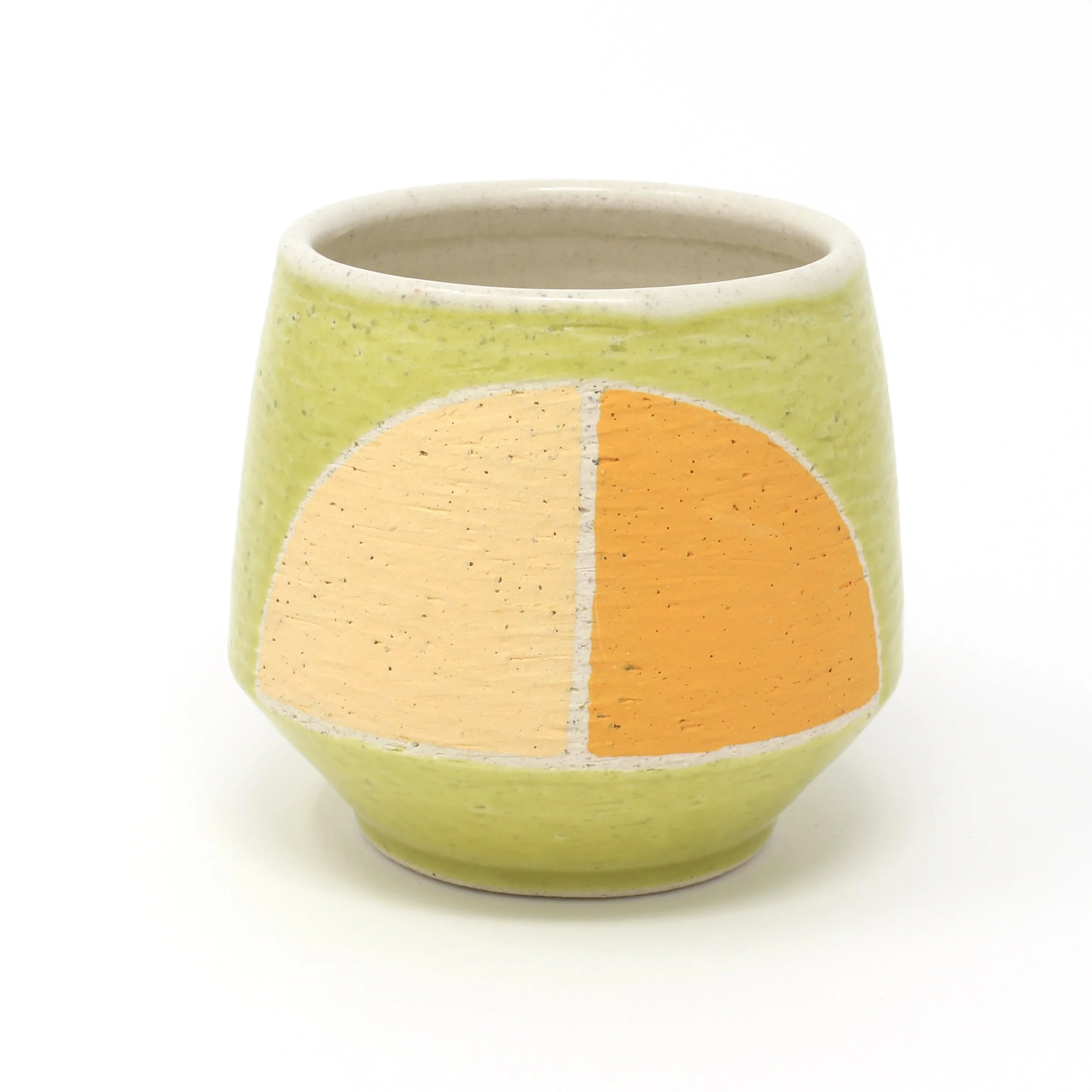 green cup with orange design