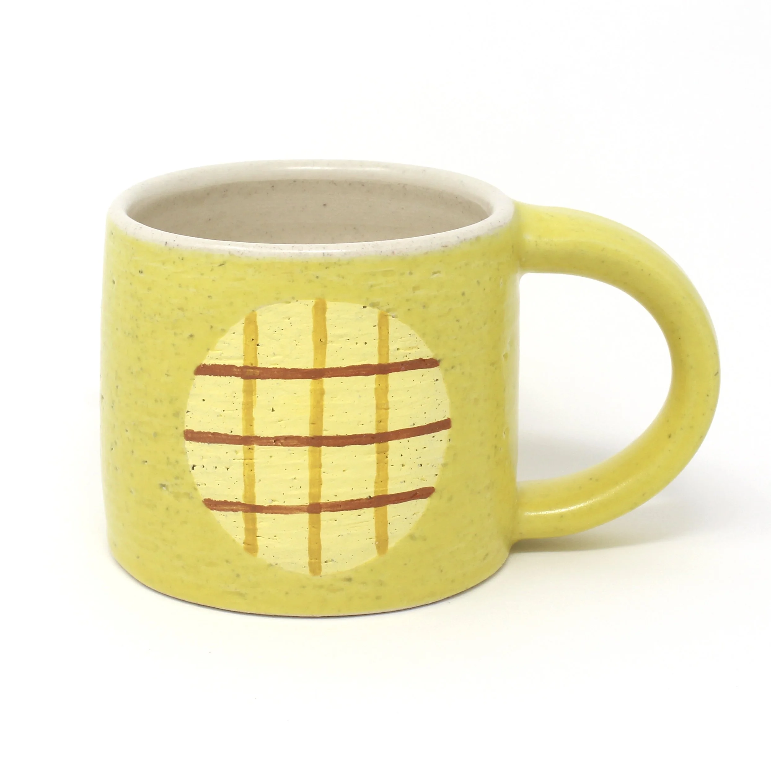 yellow cup with yellow and brown plaid design