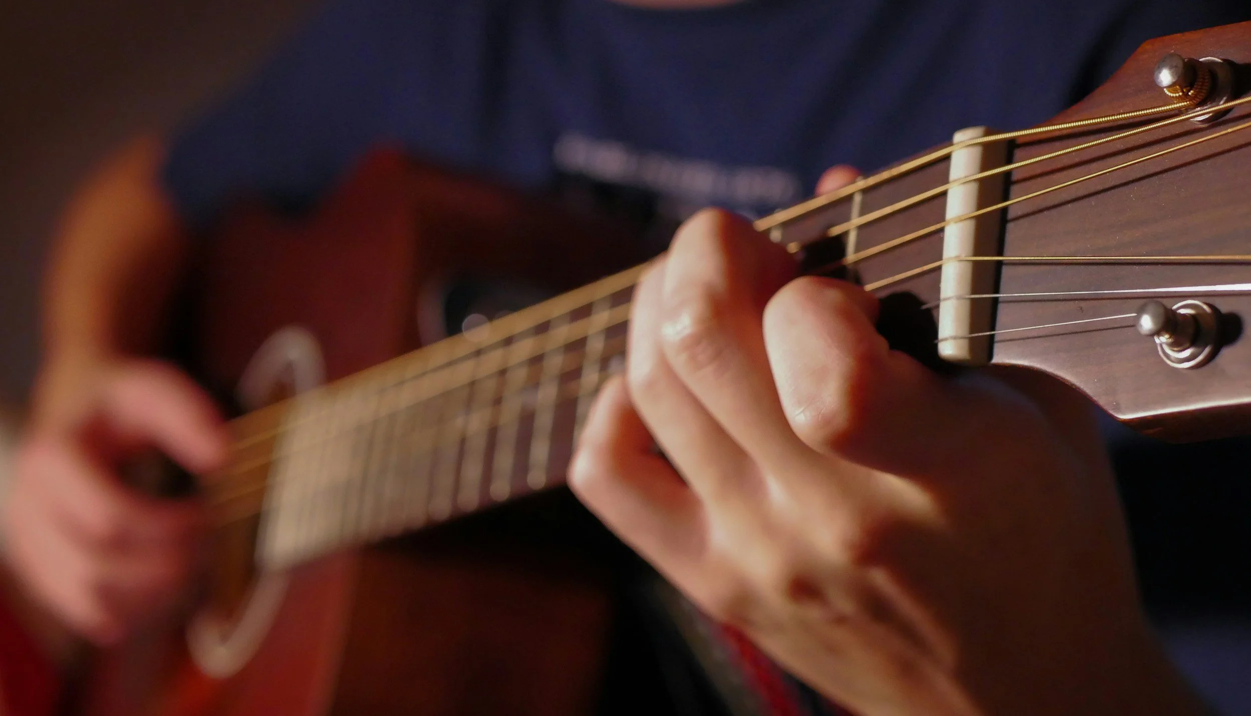Changing  chords on a guitar.
