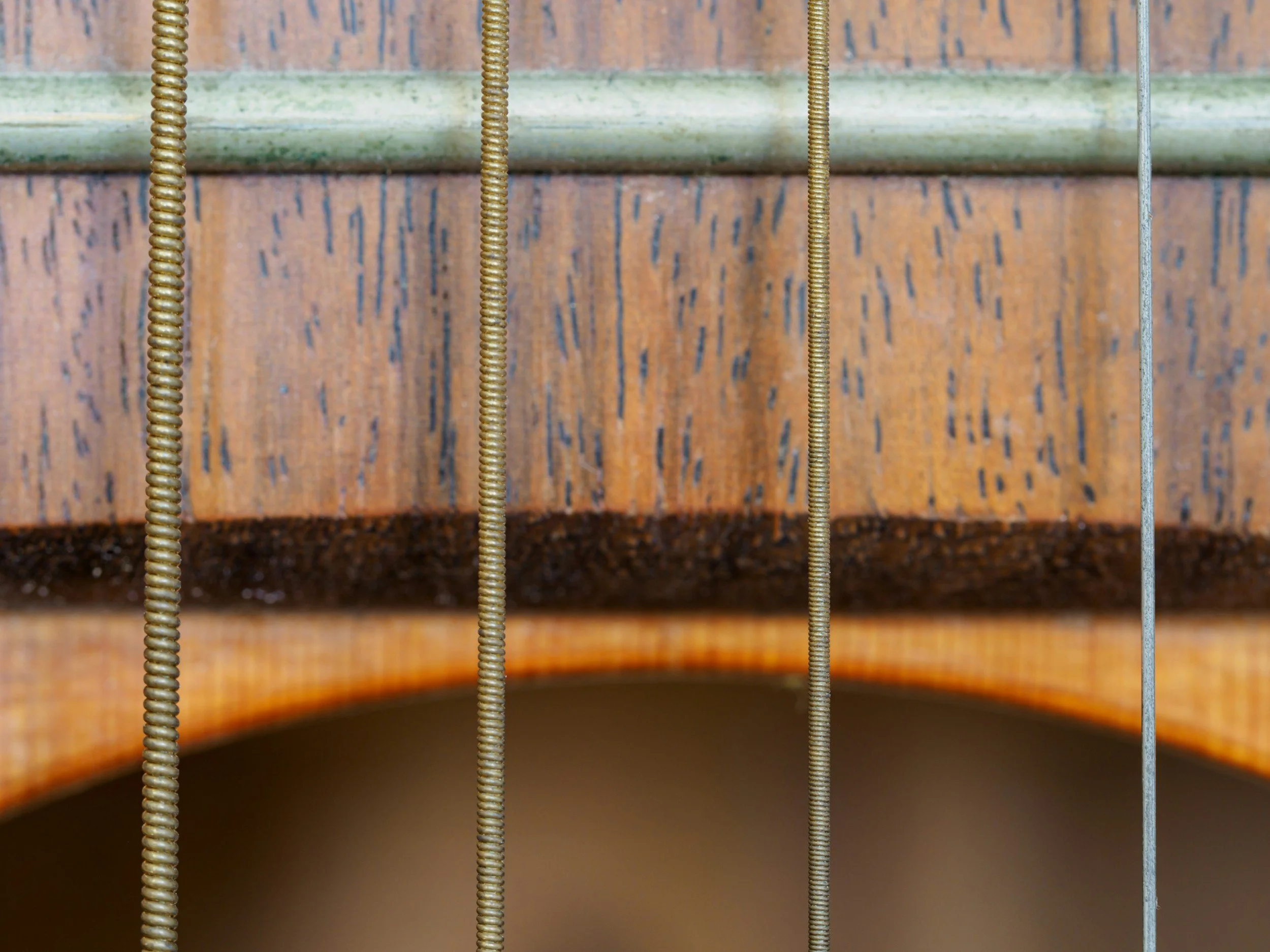 Changing guitar strings during routine guitar maintenance